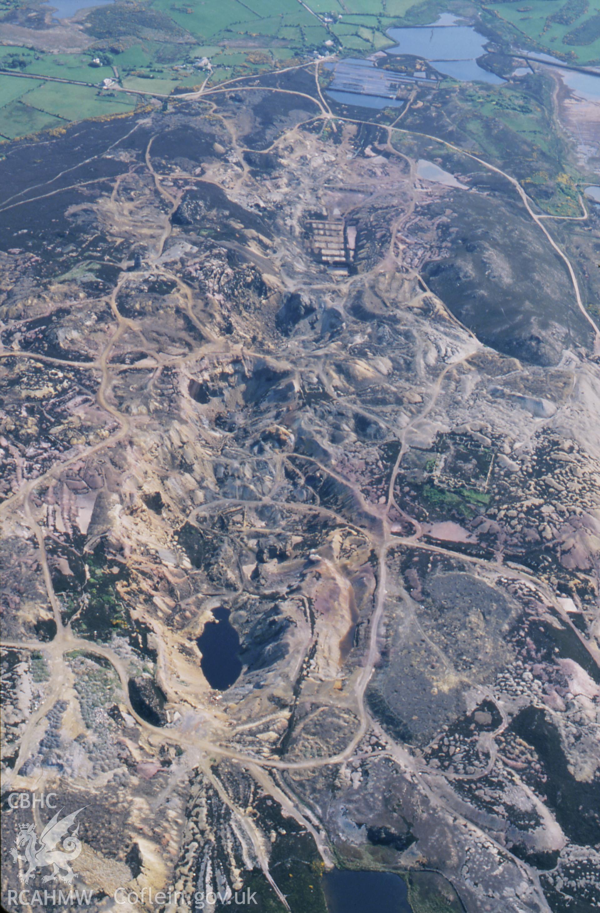 RCAHMW colour slide oblique aerial photograph of Parys Mountain Copper Mines, Amlwch, taken by C.R. Musson, 30/05/94