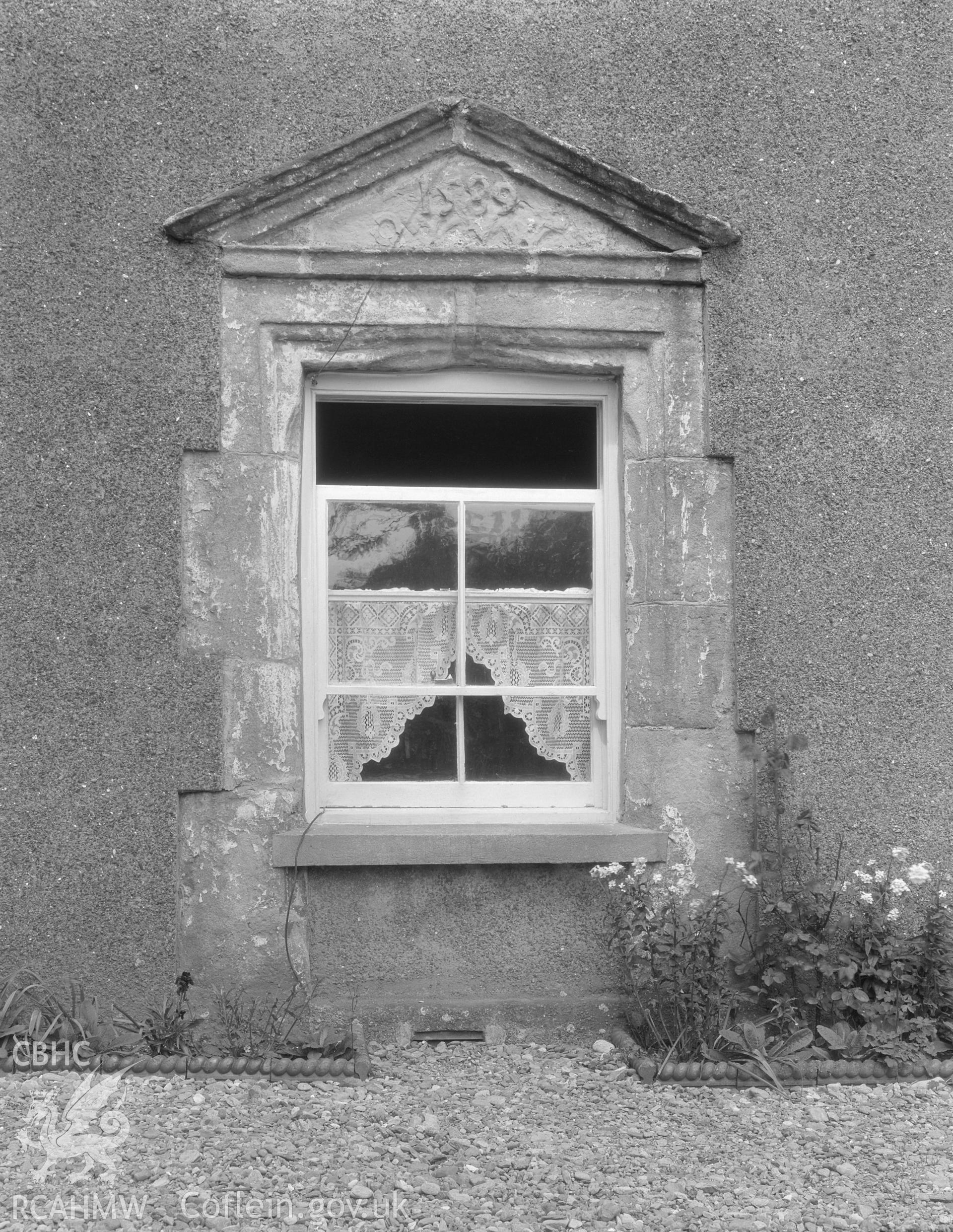 Descriptive account of Llangwyfan-Isaf, Anglesey, including investigator's notes, black and white photograph, copy of extract from RCAHMW inventory, and sketch of pediment detail.