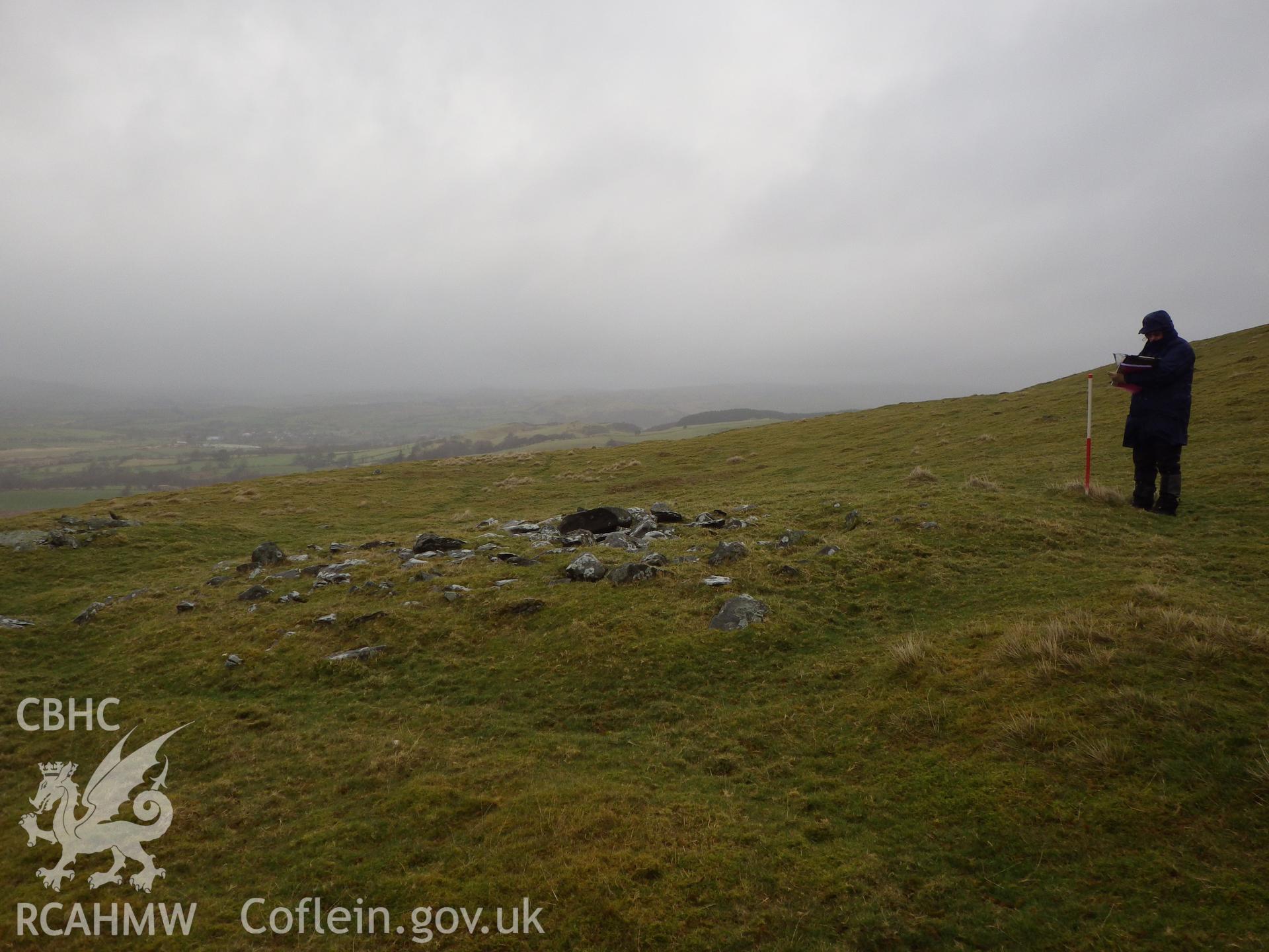 Low, grassed-over stone cairn, looking north.
