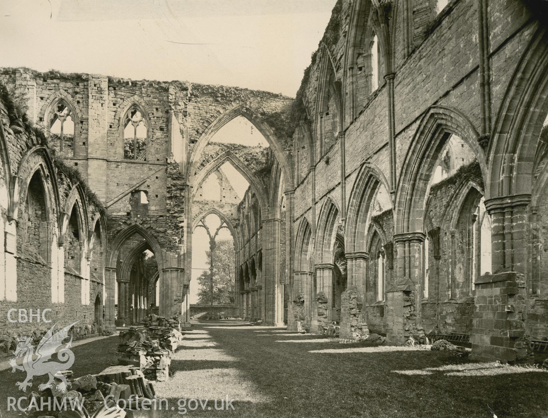 Digital copy of an early National Buildings Record photograph showing an interior view of Tintern Abbey looking east.