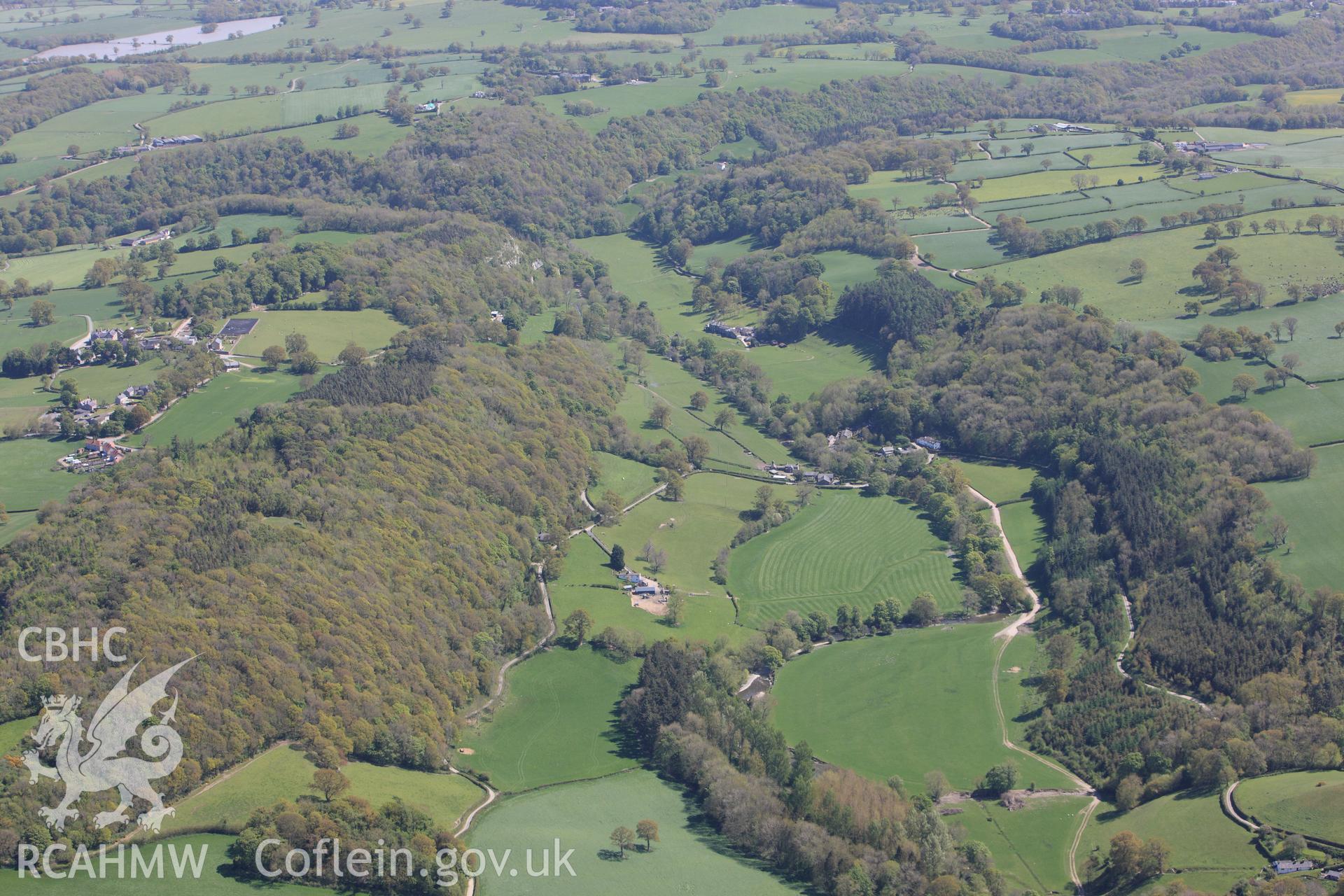 Bont Newydd Cave and Plas yn Cefn Garden, Henllan, in it's landscape. Oblique aerial photograph taken during the Royal Commission?s programme of archaeological aerial reconnaissance by Toby Driver on 22nd May 2013.