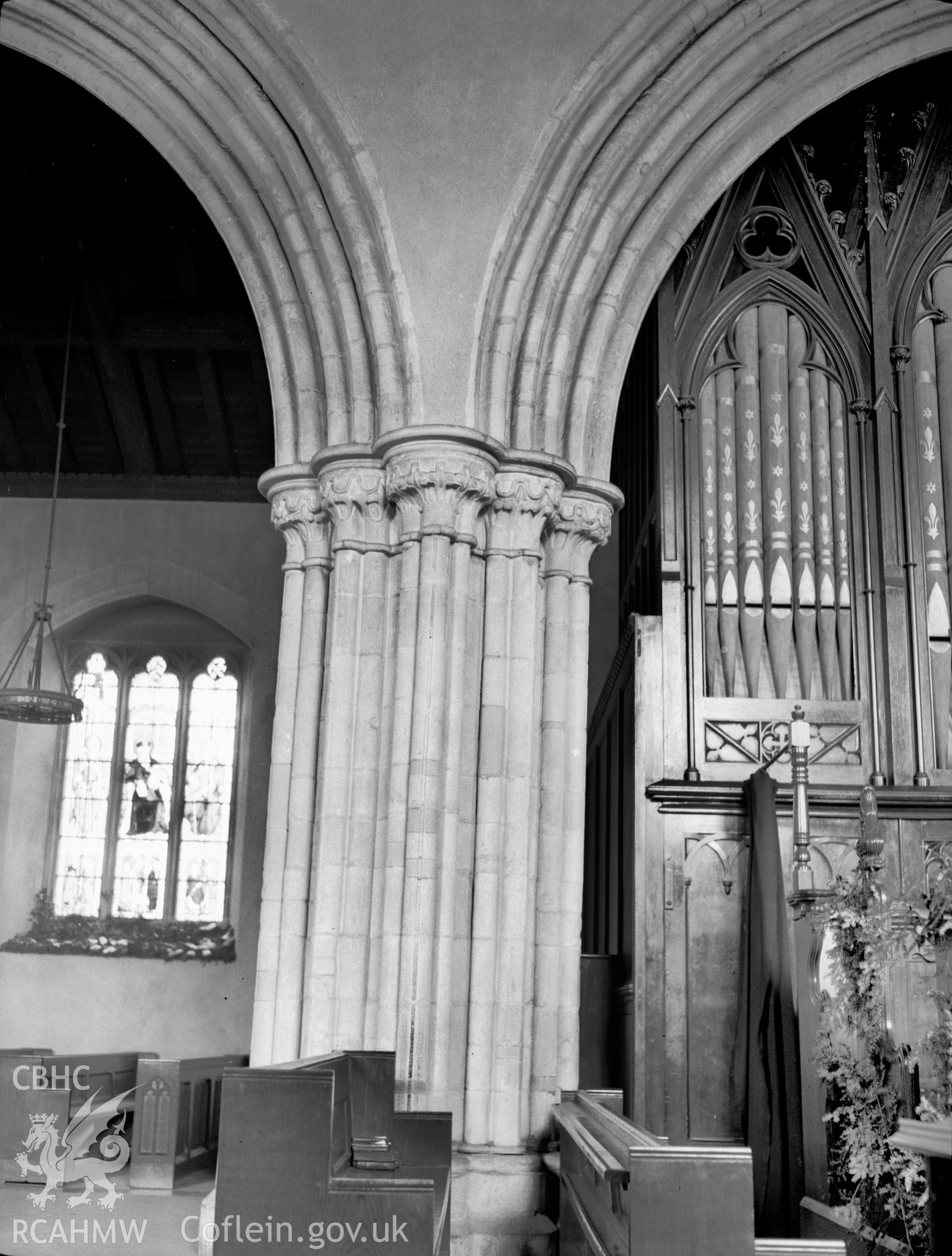 Digital copy of a nitrate negative showing interior view of arcade pillar, St Idloes' Church, Llanidloes. From the National Building Record Postcard Collection.