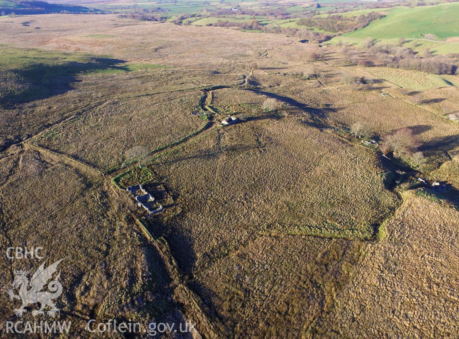 Aerial view of the ruined Ty-Newydd and its outbuilding; Gwndwn-Gwynau-Isa cottage and Cil-y-Bryn house and outbuilding, south west of Bryneithinog farm, Ystrad Fflur. Colour photograph taken by Paul R. Davis on 18th November 2018.