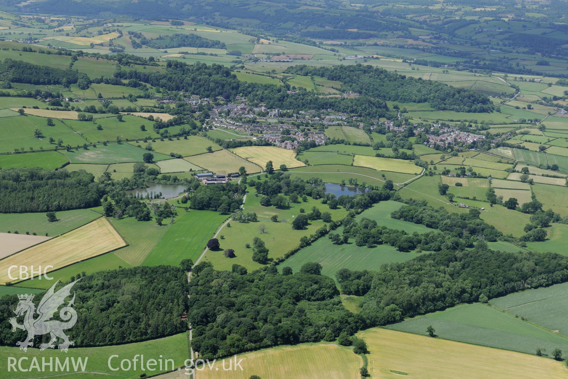 Lymore Hall and park, with the town of Montgomery beyond. Oblique aerial photograph taken during the Royal Commission's programme of archaeological aerial reconnaissance by Toby Driver on 30th June 2015.