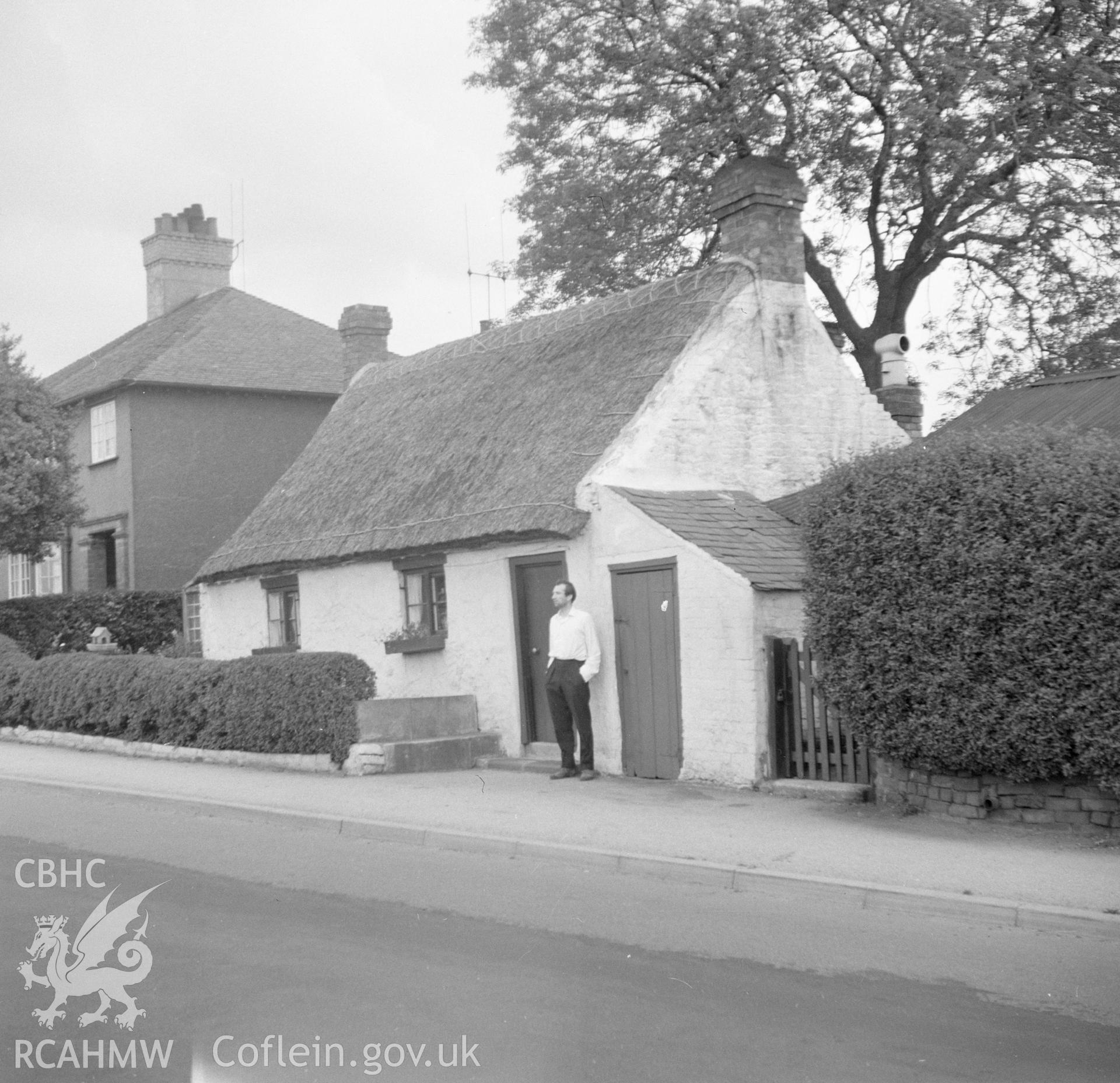 Digital copy of a black and white nitrate negative showing exterior view of an unnamed thatched cottage near Hawarden.