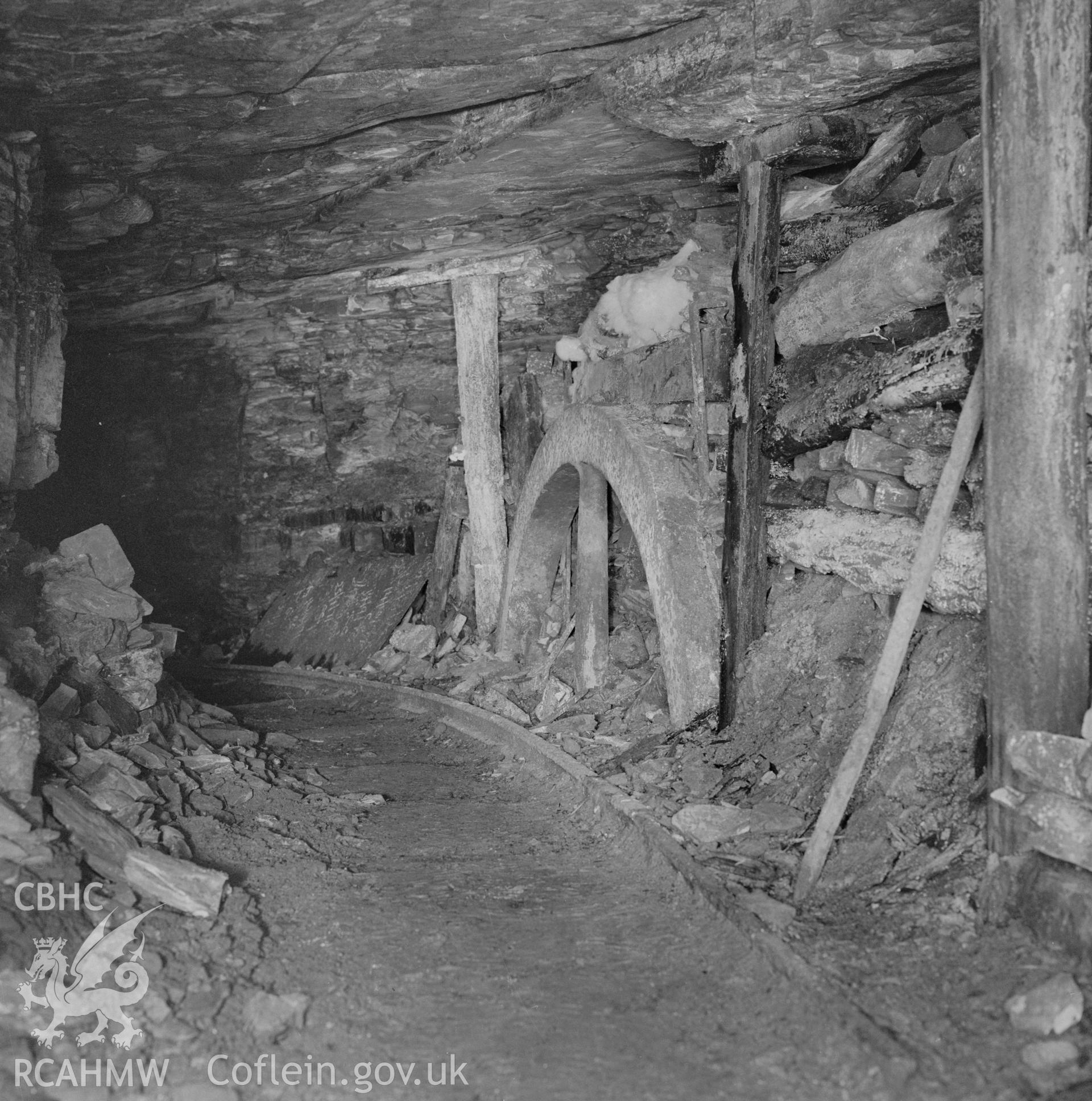 Digital copy of an acetate negative showing engine pit Level at Big Pit - old fly wheel used in pack,  from the John Cornwell Collection.