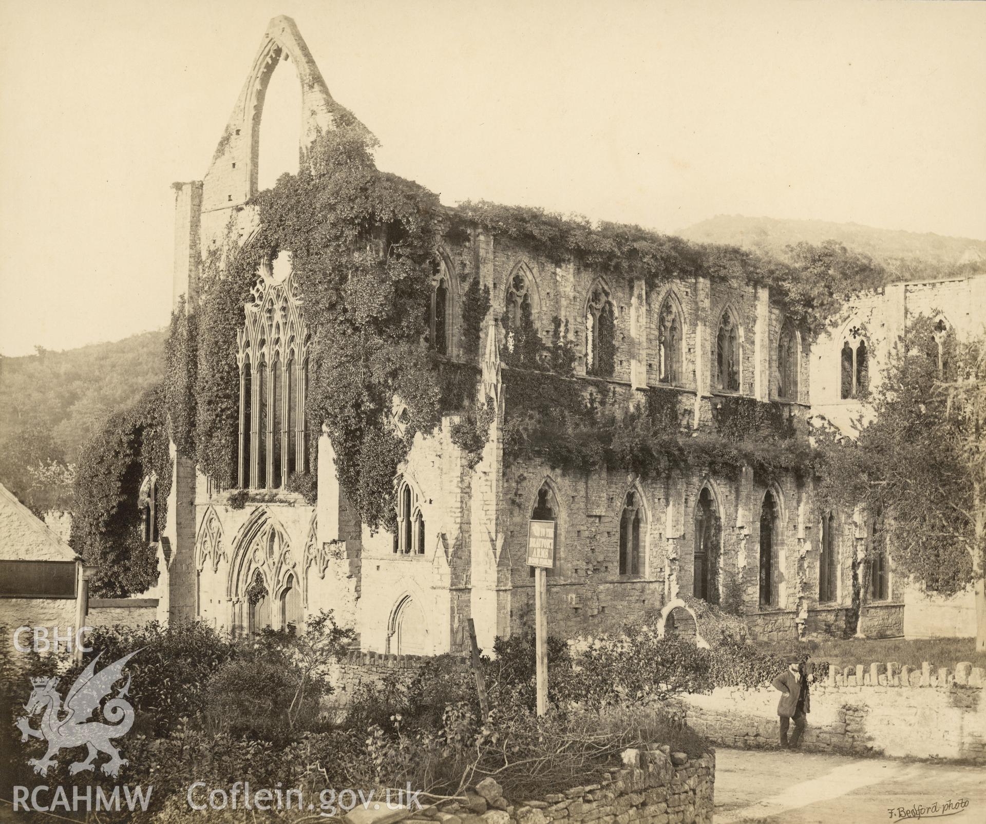 Digital copy of an albumen print showing a general view of Tintern Abbey with figure c1895.