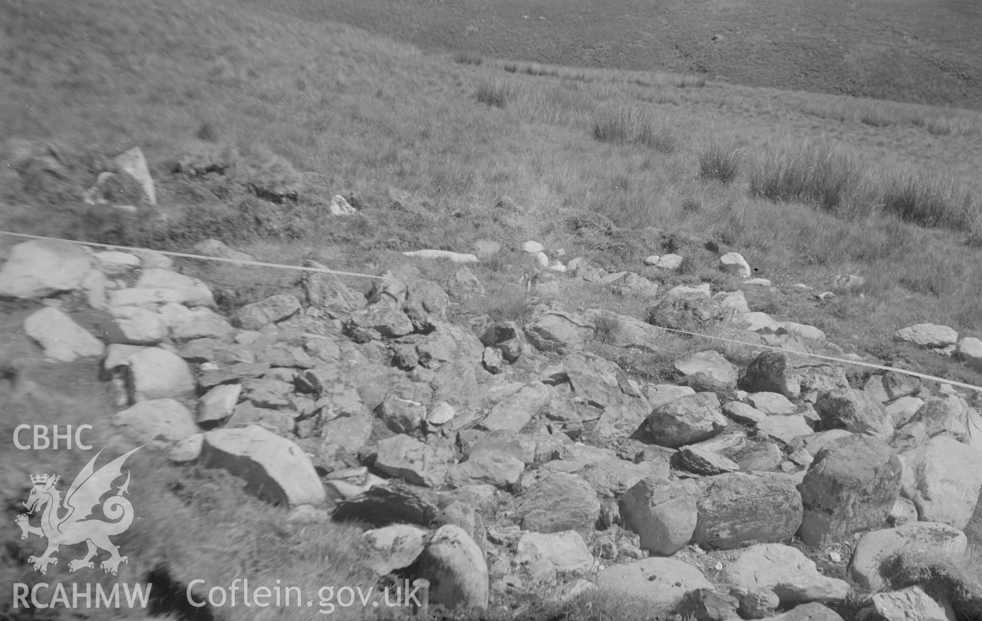 Digital copy of a black and white nitrate negative showing view of the remains of a stove site in a field, unknown location.