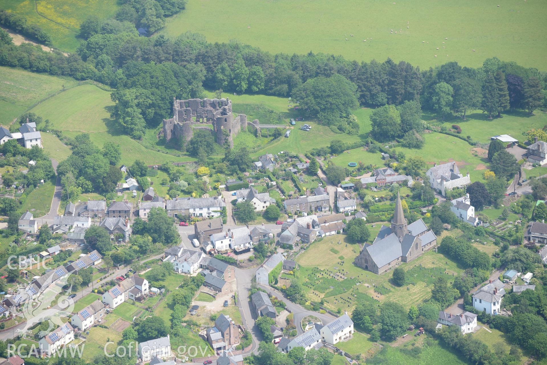 Grosmont village including the castle; St. Nicholas' church; town hall; town farm & Athelstone Guesthouse. Oblique aerial photograph taken during the Royal Commission's programme of archaeological aerial reconnaissance by Toby Driver on 11th June 2015.