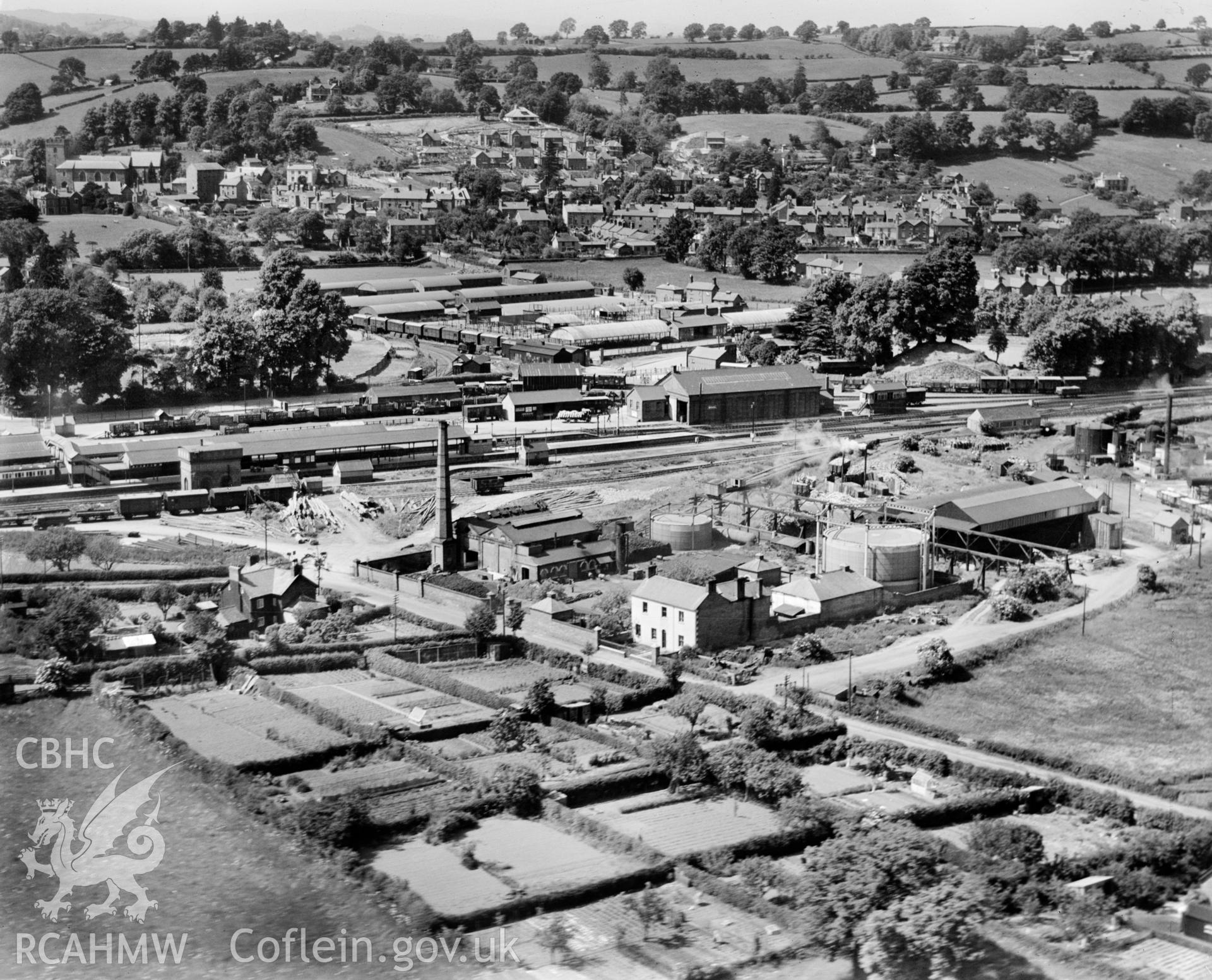 View of the Severn Valley Gas Co. works at Welshpool, also showing railway station with trains and Smithfield market. Oblique aerial photograph, 5?x4? BW glass plate.
