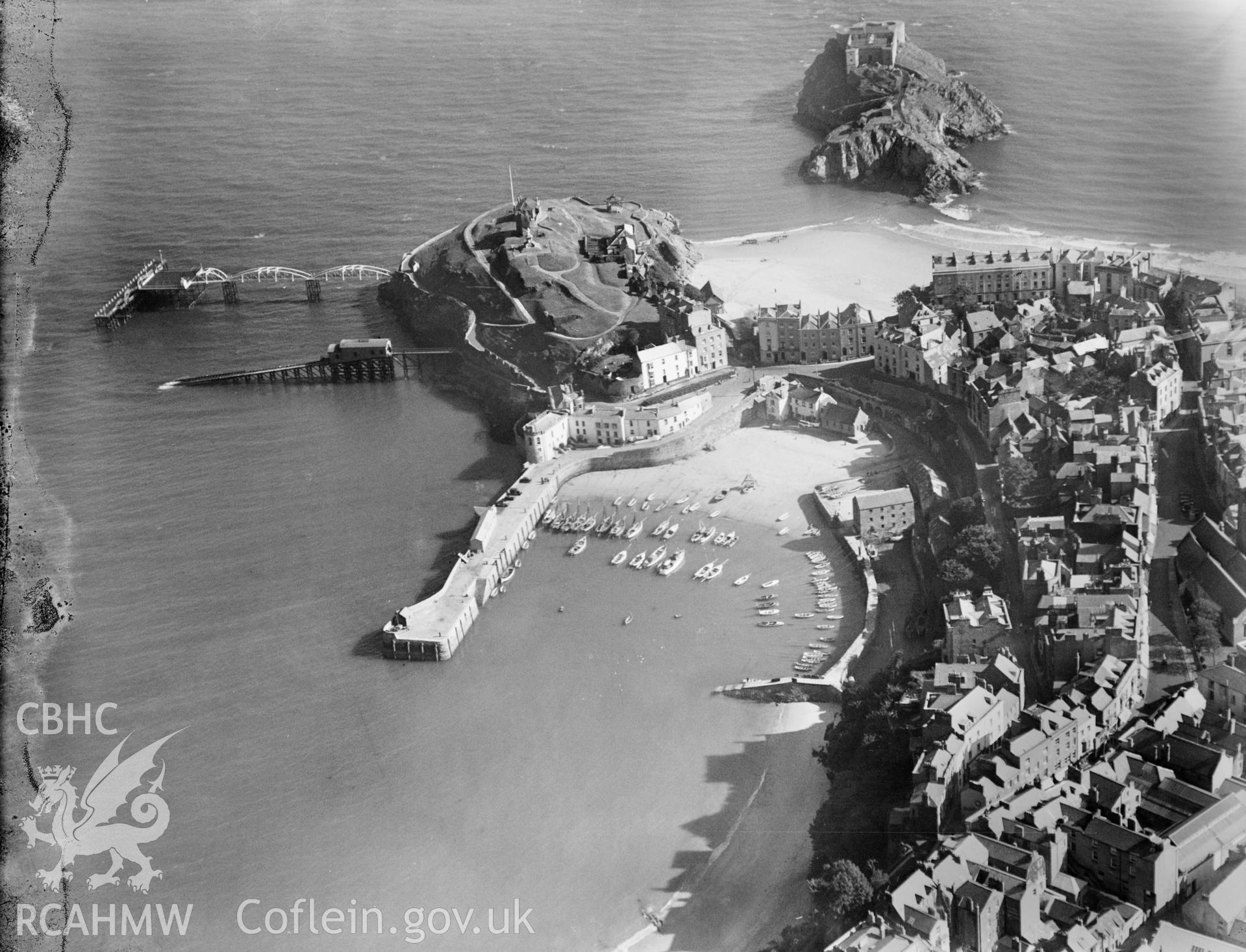 View of Tenby Harbour, Castle Hill and St. Catherines Rocks, oblique aerial view. 5?x4? black and white glass plate negative.