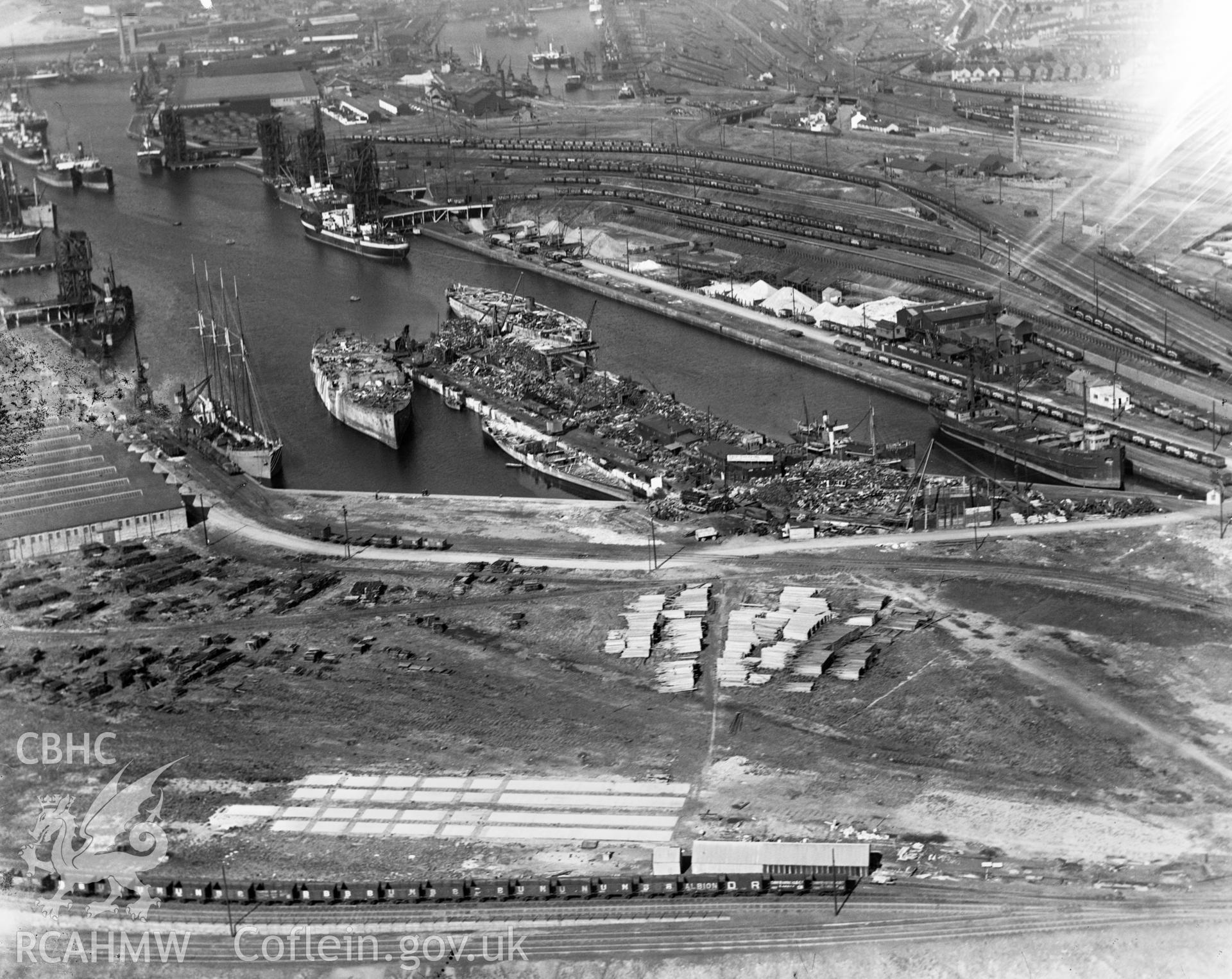 View of Swansea docks showing T. W. Ward's new scrapping berth at the eastern end of Kings Dock, oblique aerial view. 5?x4? black and white glass plate negative.
