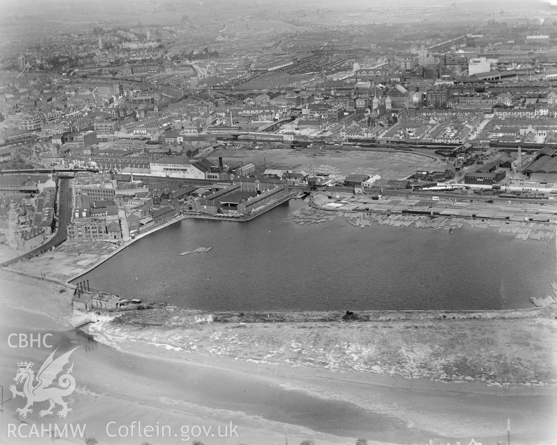 View of Cardiff showing timber ponds in Butetown, includes Welsh Hills lemonade works and the Cardiff Pure Ice and storage factory, oblique aerial view. 5?x4? black and white glass plate negative.