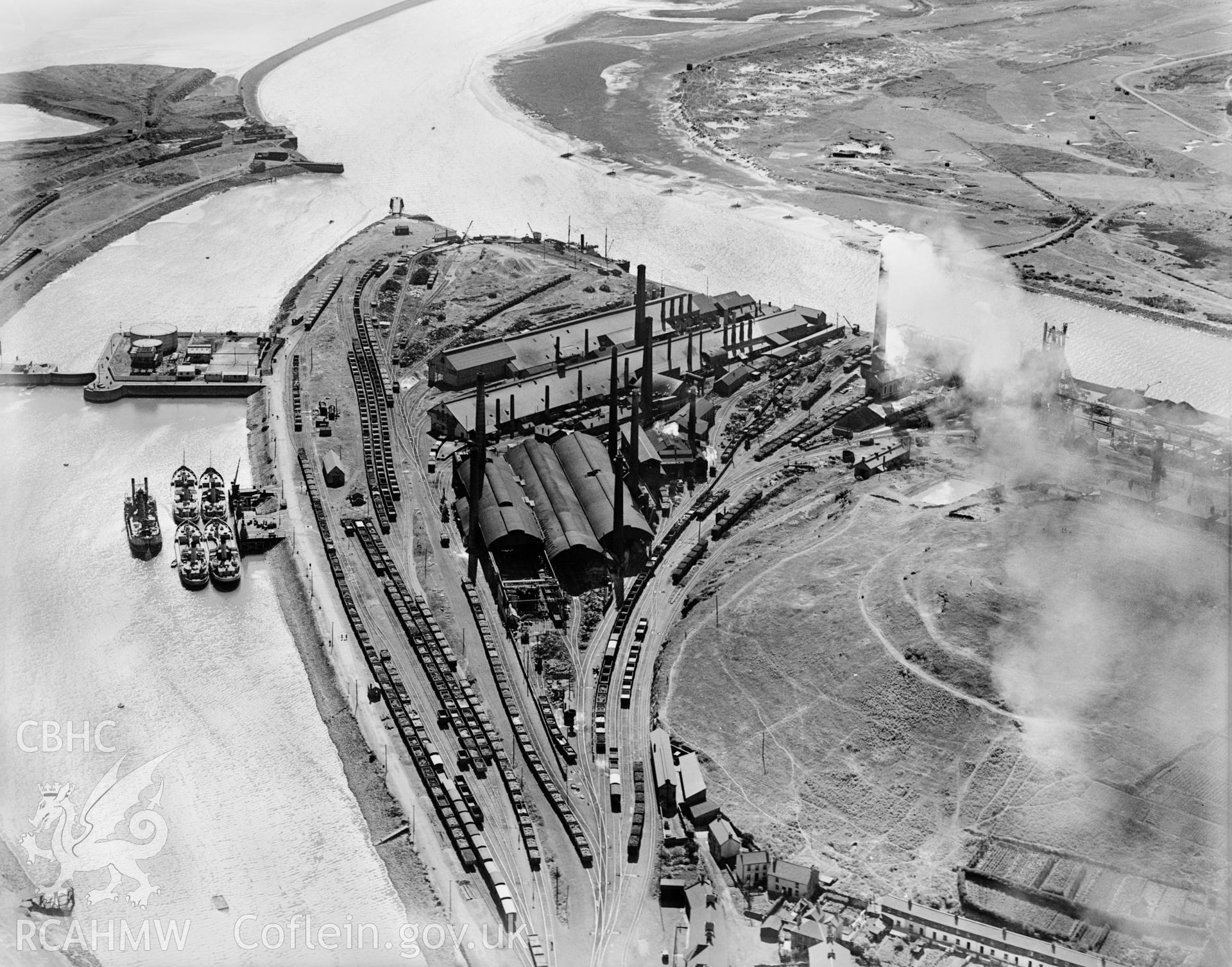 View of Neath River Navigation at Briton Ferry showing Briton Ferry dock, Cambria Cokeworks, Gwalia and Victoria tinplate works and Britain Ferry steelworks, oblique aerial view. 5?x4? black and white glass plate negative.