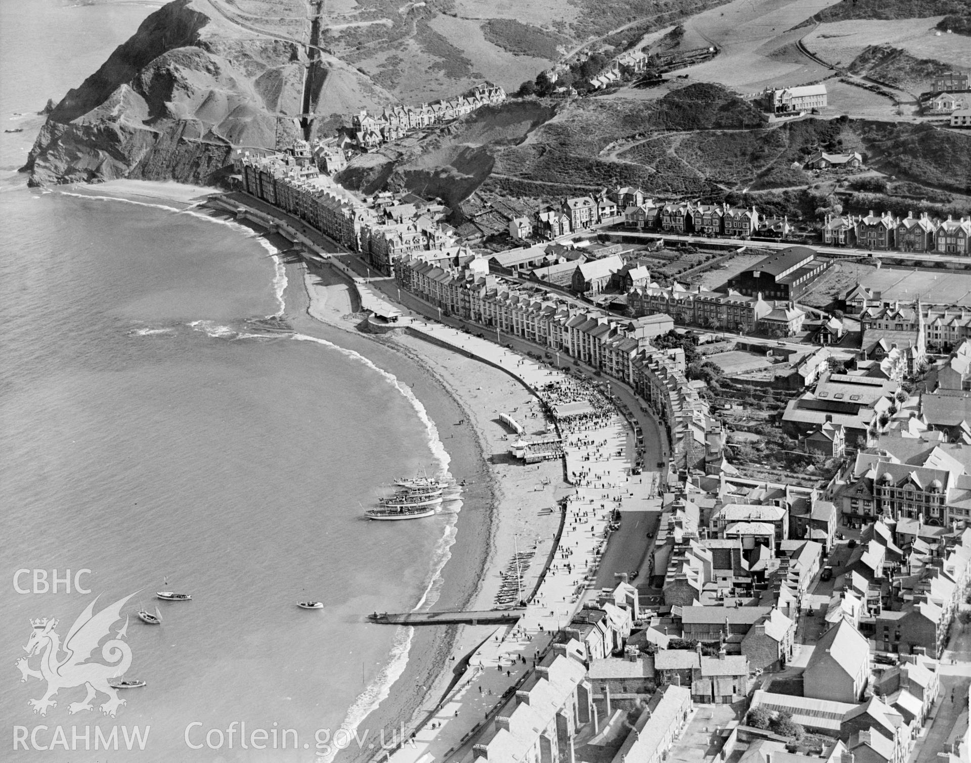 General view of Aberystwyth showing seafront and town in summer, oblique aerial view. 5?x4? black and white glass plate negative.