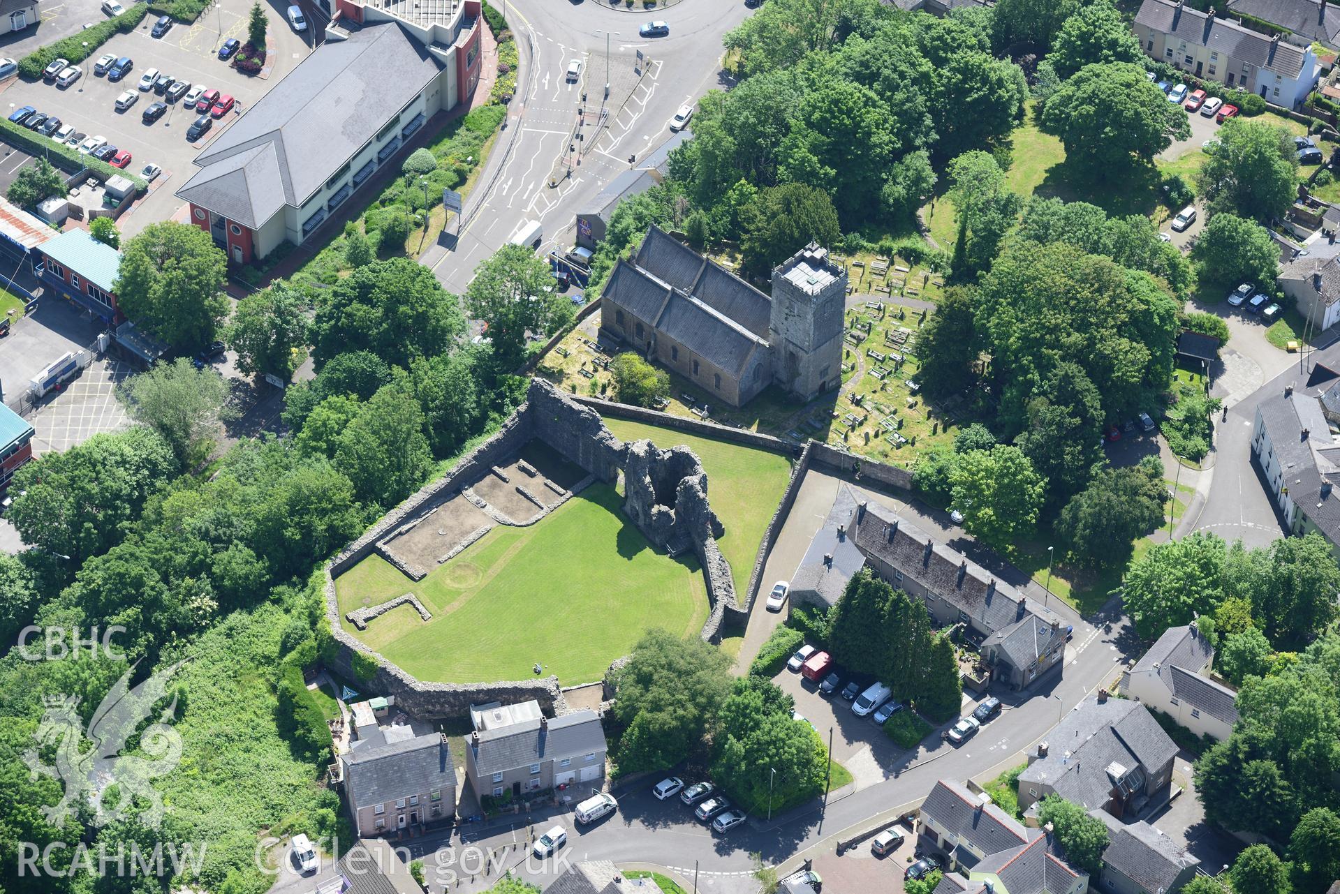Wide view of the town of Bridgend including St. Illtyd's Church and Newcastle castle. Oblique aerial photograph taken during the Royal Commission's programme of archaeological aerial reconnaissance by Toby Driver on 19th June 2015.