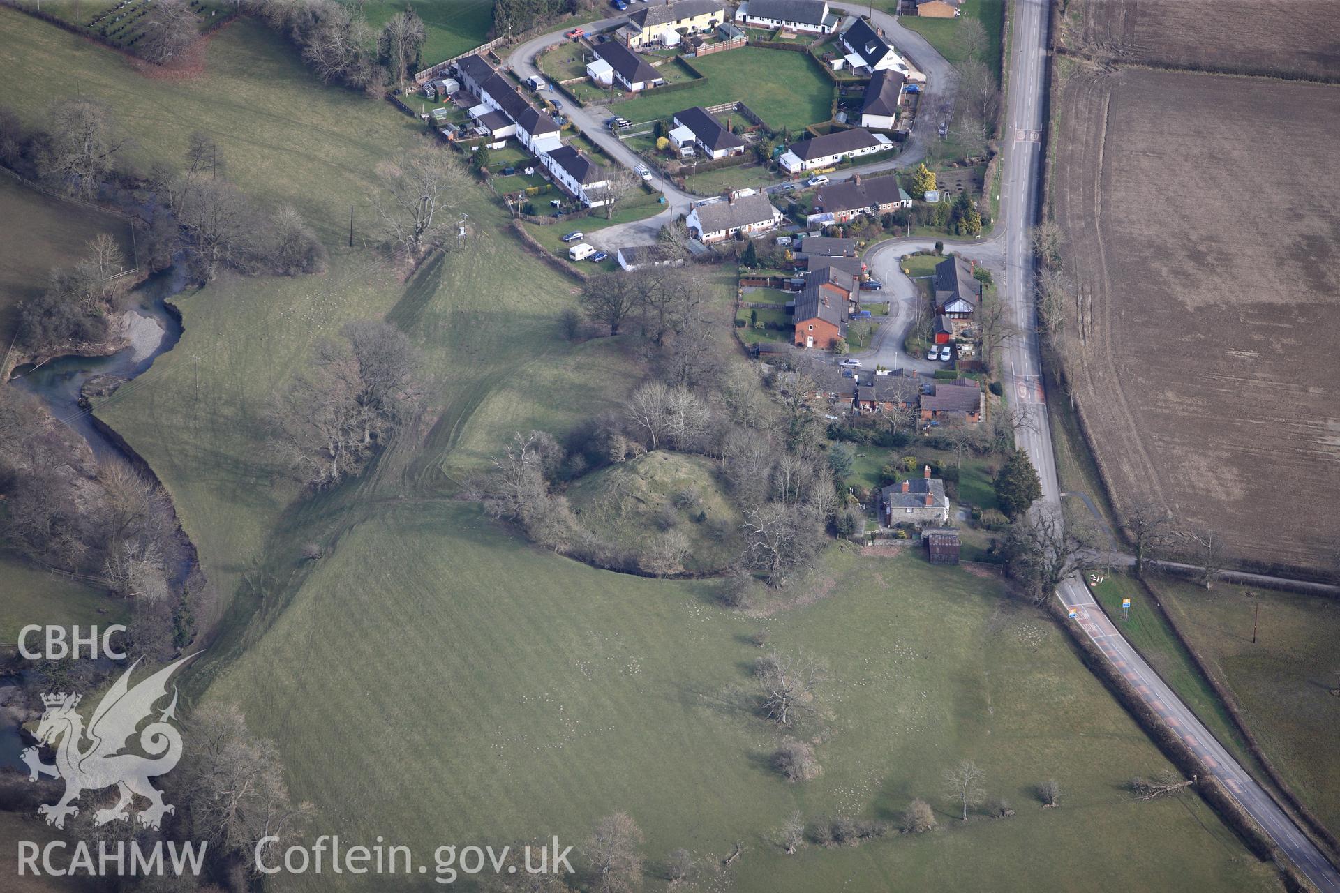 Domen Gastell and the village of Llanfechain, north of Welshpool. Oblique aerial photograph taken during the Royal Commission?s programme of archaeological aerial reconnaissance by Toby Driver on 28th February 2013.