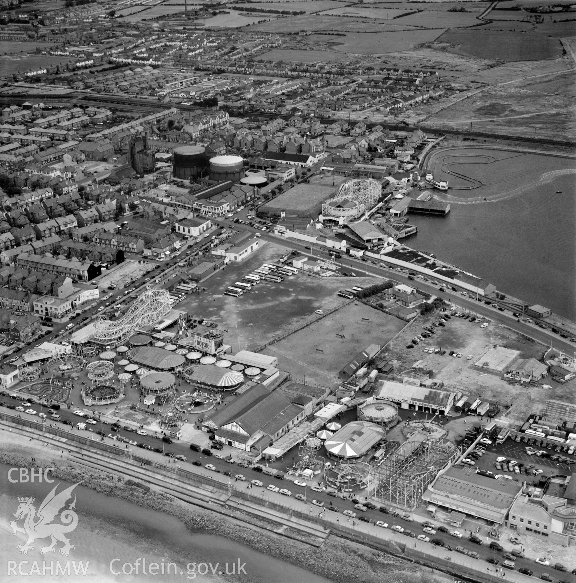 Black and white oblique aerial photograph showing the Marine Lake and funfair in the town of Rhyl  dated 18th July 1961, from Aerofilms album Flints M-Z (W17).