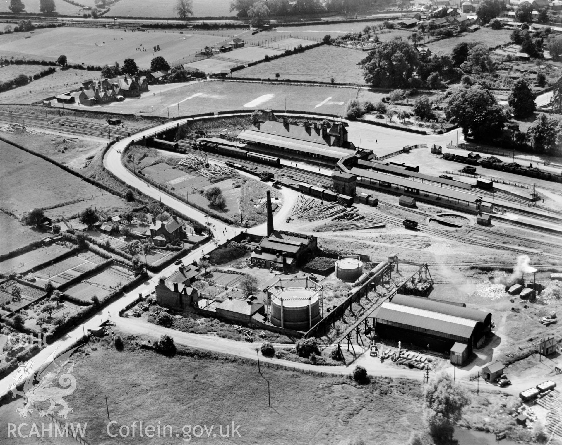 View of the Severn Valley Gas Co. works at Welshpool, also showing railway station with trains and the County school. Oblique aerial photograph, 5?x4? BW glass plate.