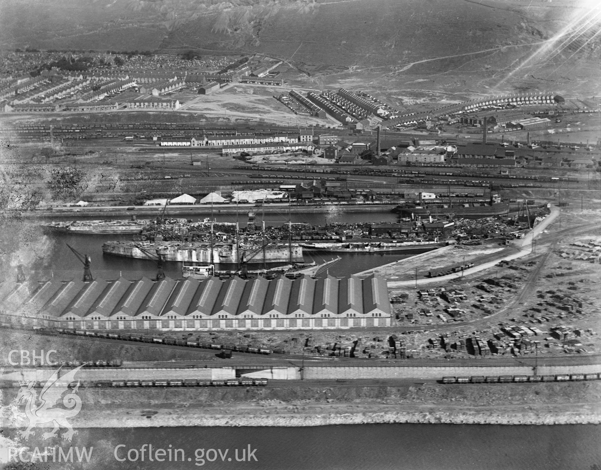 View of Swansea docks showing T. W. Ward's new scrapping berth at the eastern end of Kings Dock, oblique aerial view. 5?x4? black and white glass plate negative.