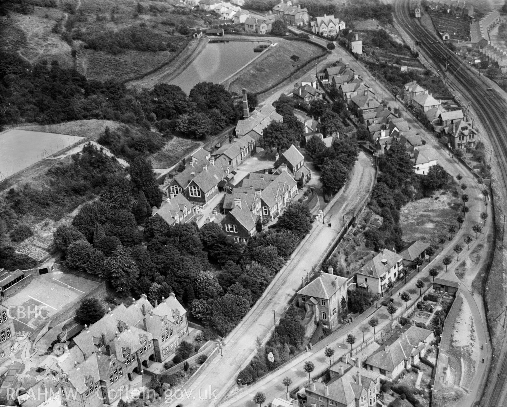 View of Pontypridd showing Grammar school, tennis courts and Lan Wood reservoir, oblique aerial view. 5?x4? black and white glass plate negative.