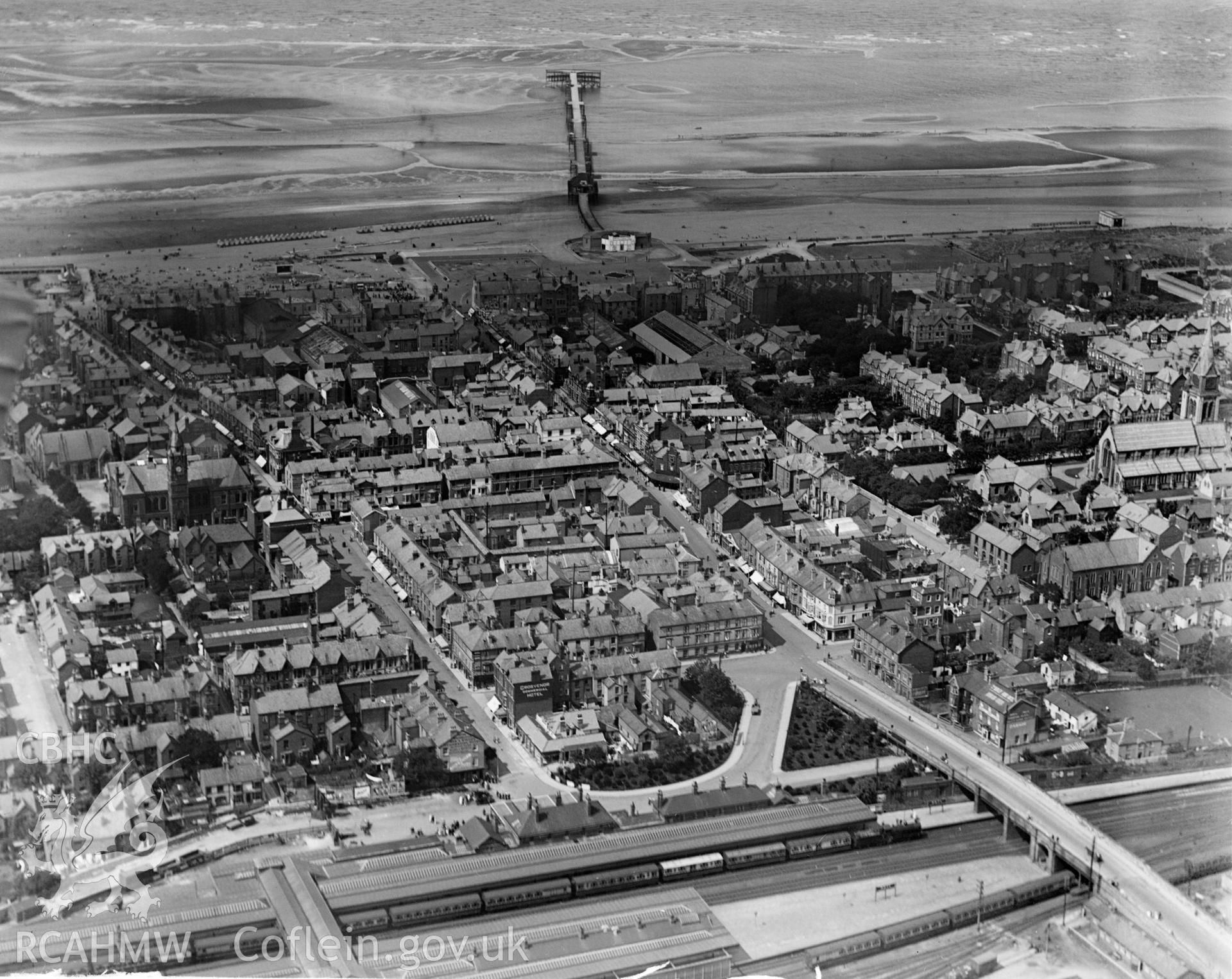 View of Rhyl showing railway station and pier, oblique aerial view. 5?x4? black and white glass plate negative.