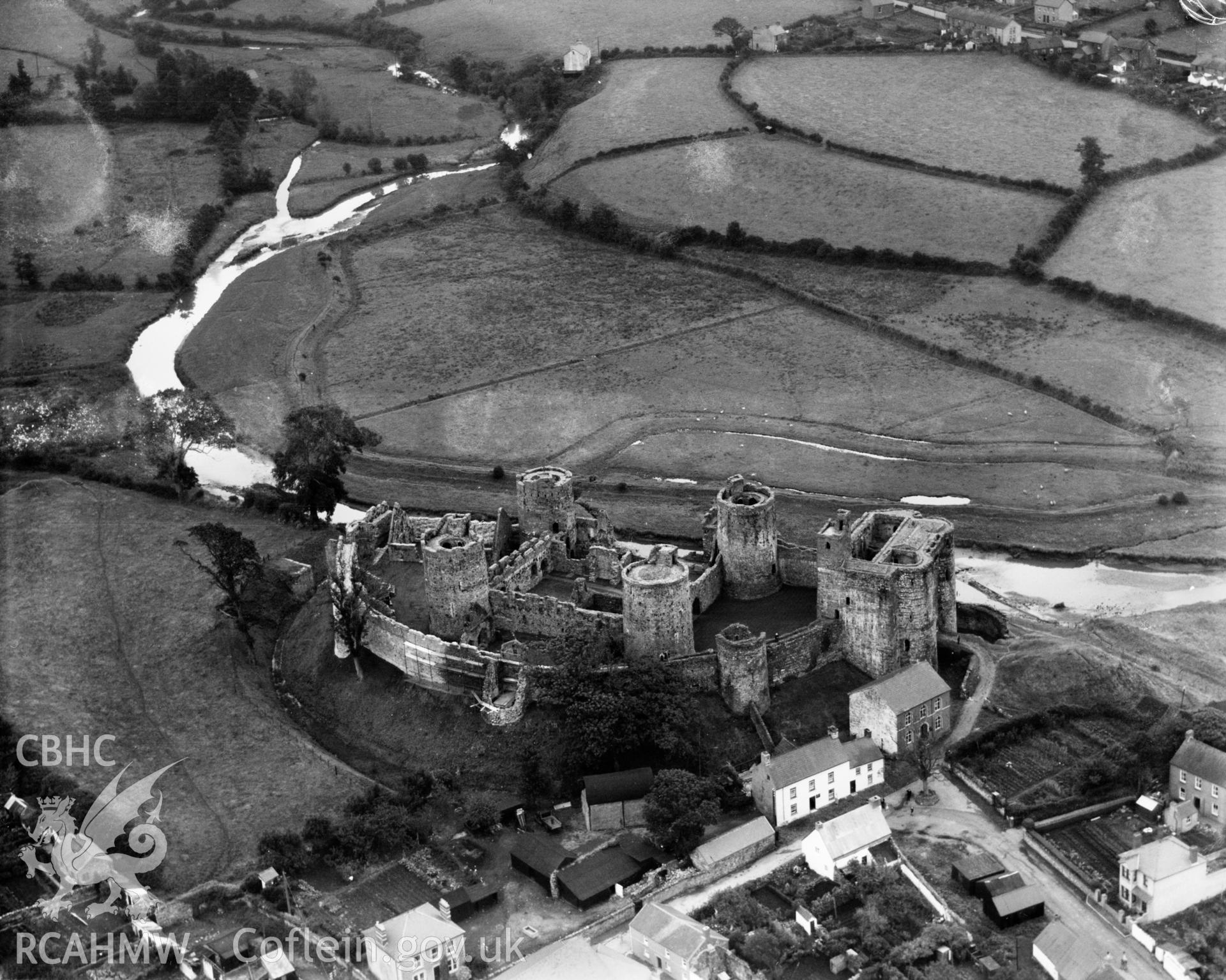 View of Kidwelly Castle showing nearby buildings, oblique aerial view. 5?x4? black and white glass plate negative.