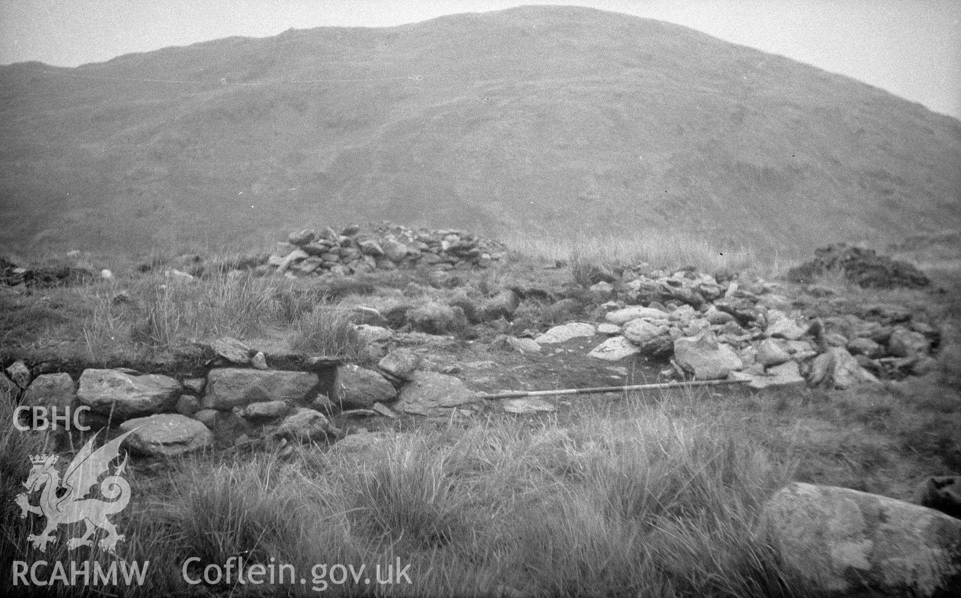 Digital copy of a black and white nitrate negative showing view of the remains of a stove site in a field, unknown location.