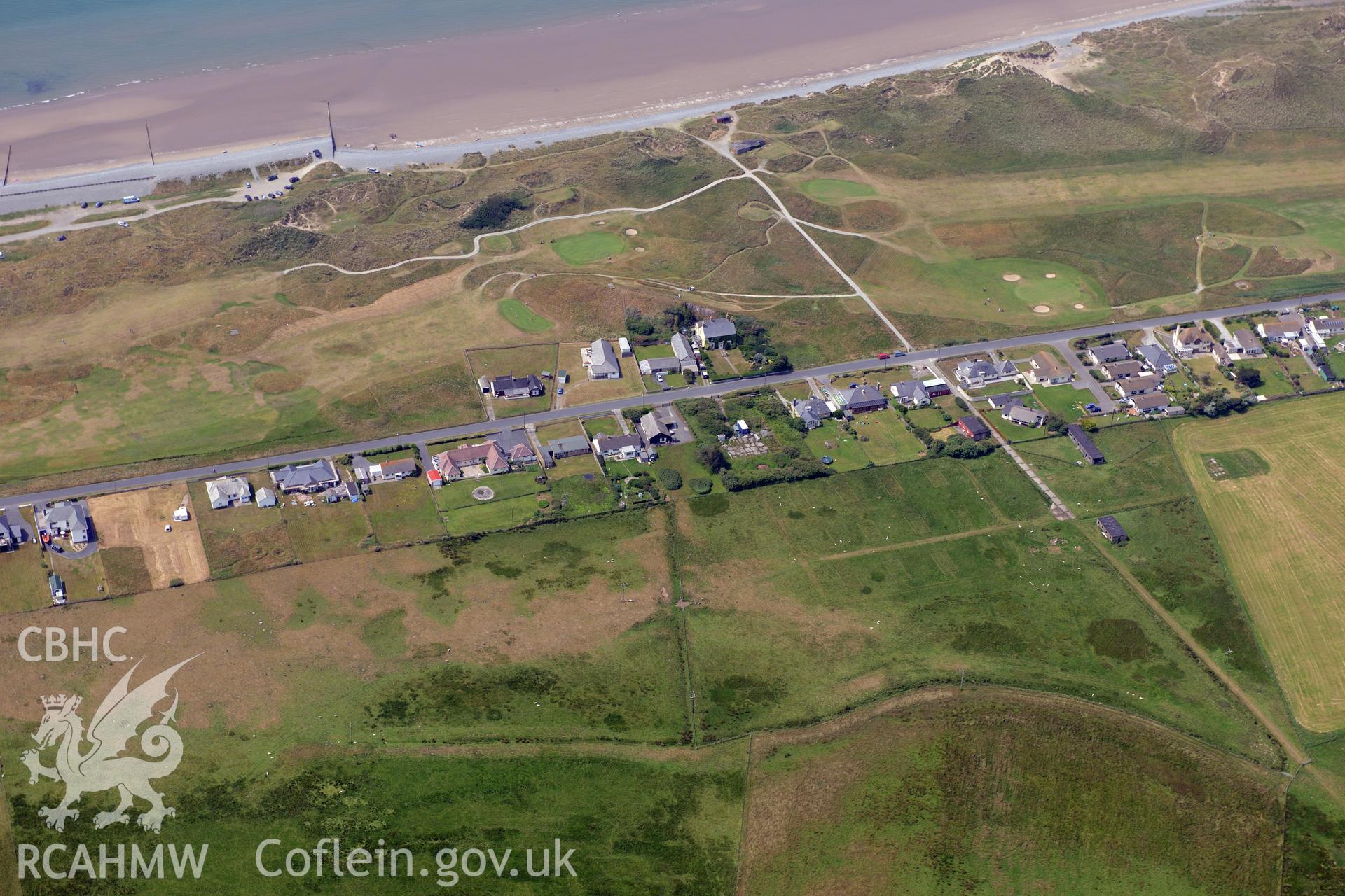 Ynyslas rocket range and the village of Ynys Las, Ceredigion. Oblique aerial photograph taken during the Royal Commission?s programme of archaeological aerial reconnaissance by Toby Driver on 12th July 2013.