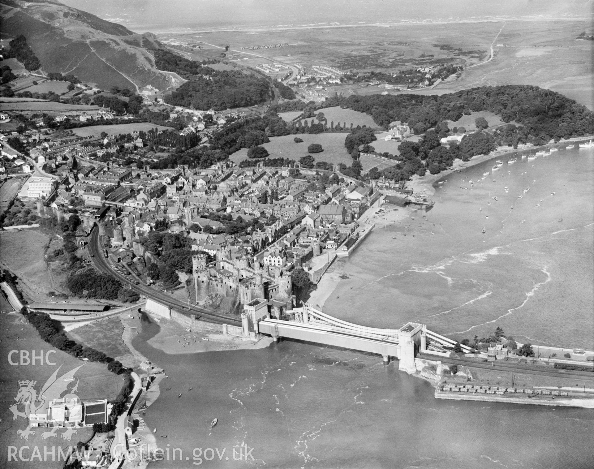 General view of Conwy showing castle and mussel purification plant in foreground, oblique aerial view. 5?x4? black and white glass plate negative.