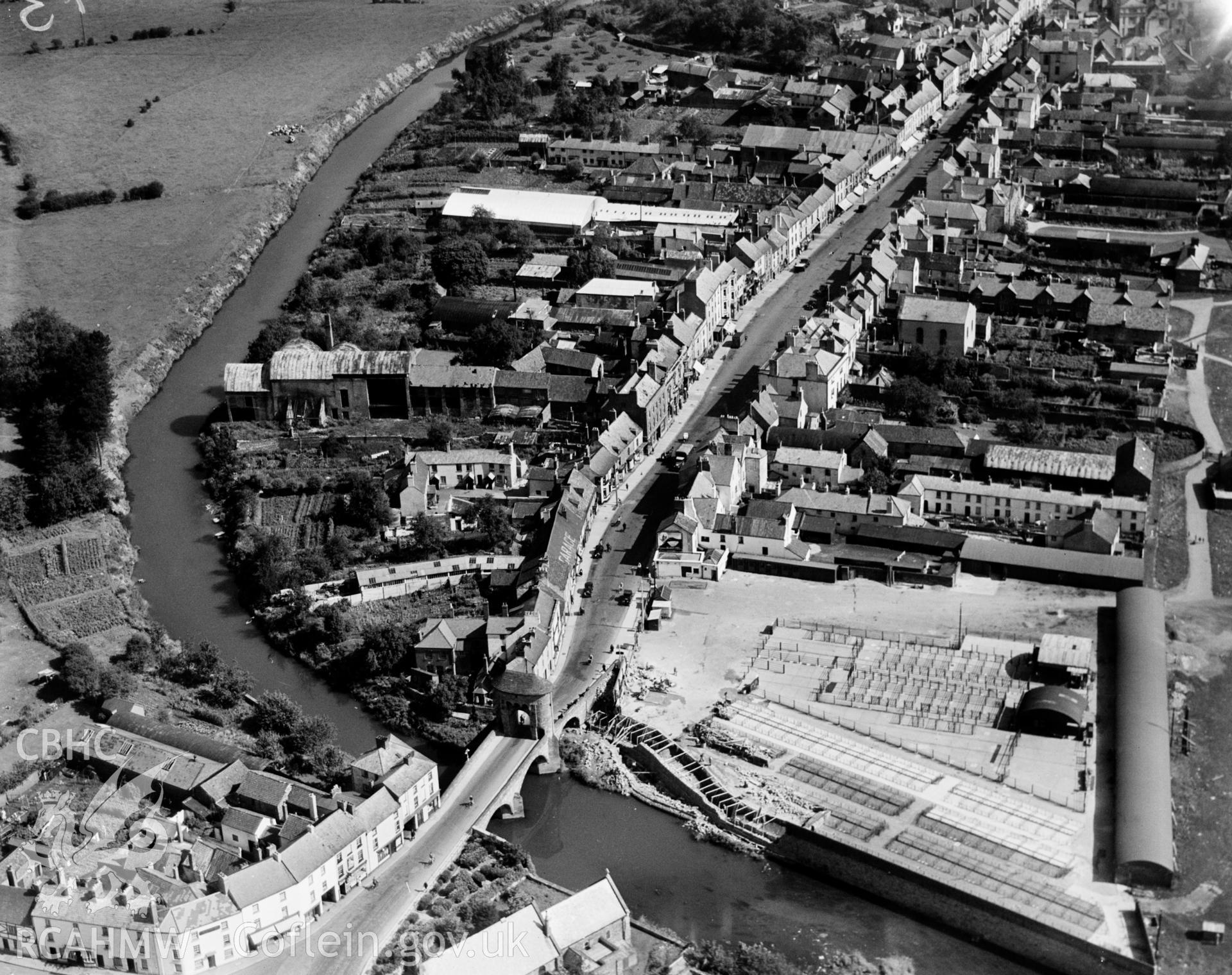View of Monmouth showing Monnow Bridge,  Monnow Street and Cattle Market, oblique aerial view. 5?x4? black and white glass plate negative.