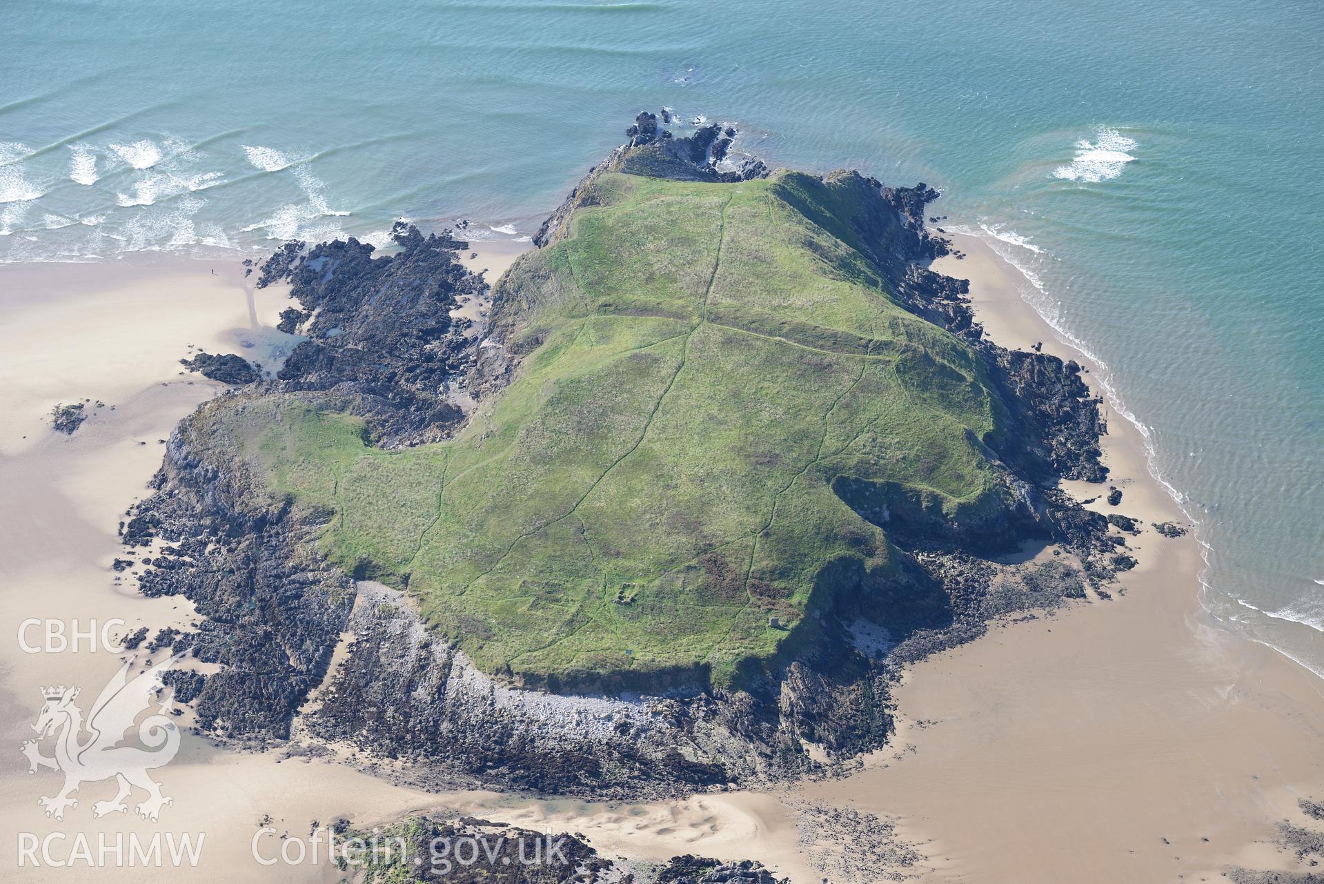 Burry Holms, with its promontory fort and medieval hermitage site, on the western coast of the Gower Peninsula. Oblique aerial photograph taken during the Royal Commission's programme of archaeological aerial reconnaissance by Toby Driver on 30th September 2015.