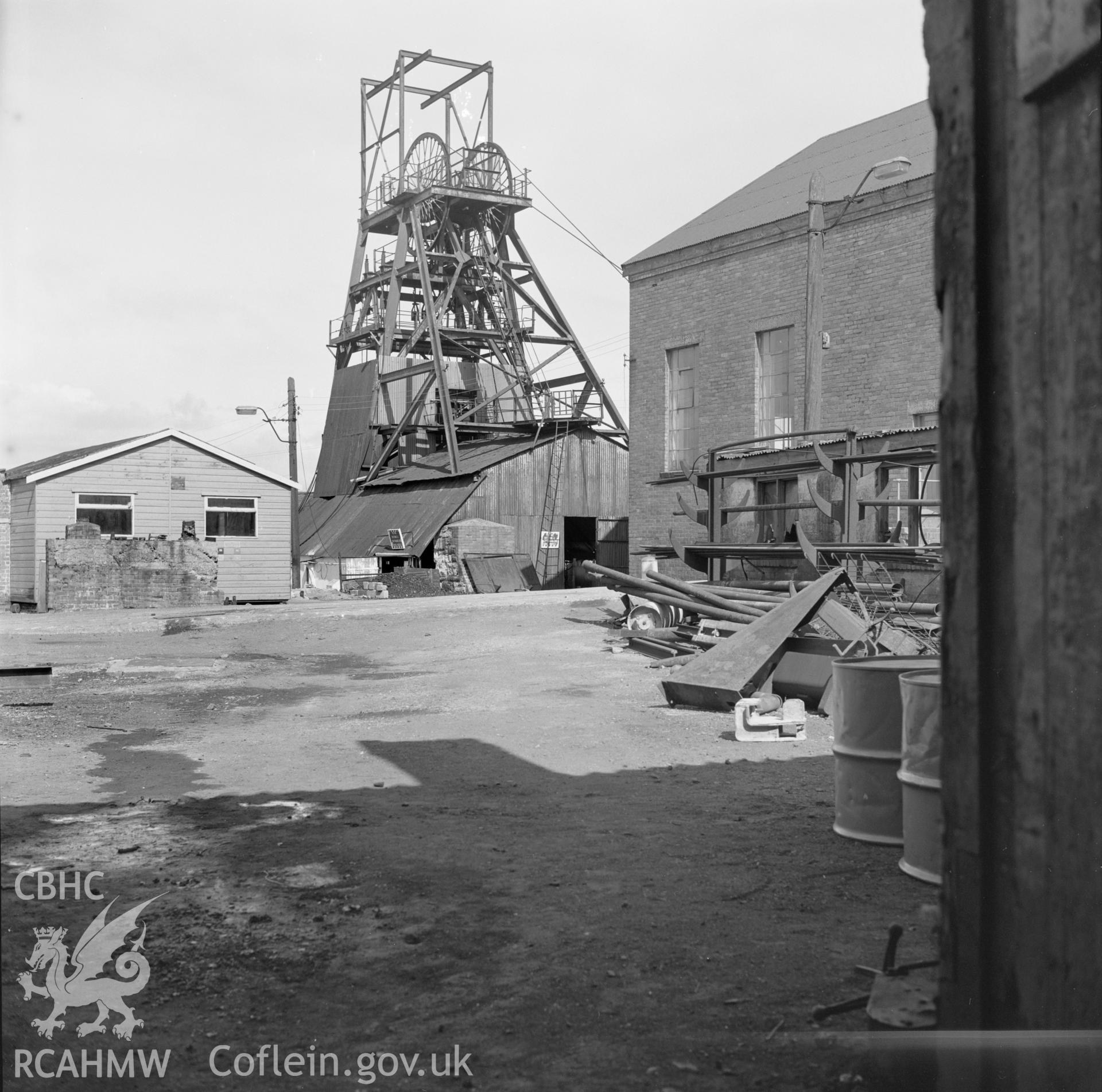 Digital copy of an acetate negative showing headframe from yard of blacksmith's shop at Big Pit, from the John Cornwell Collection.