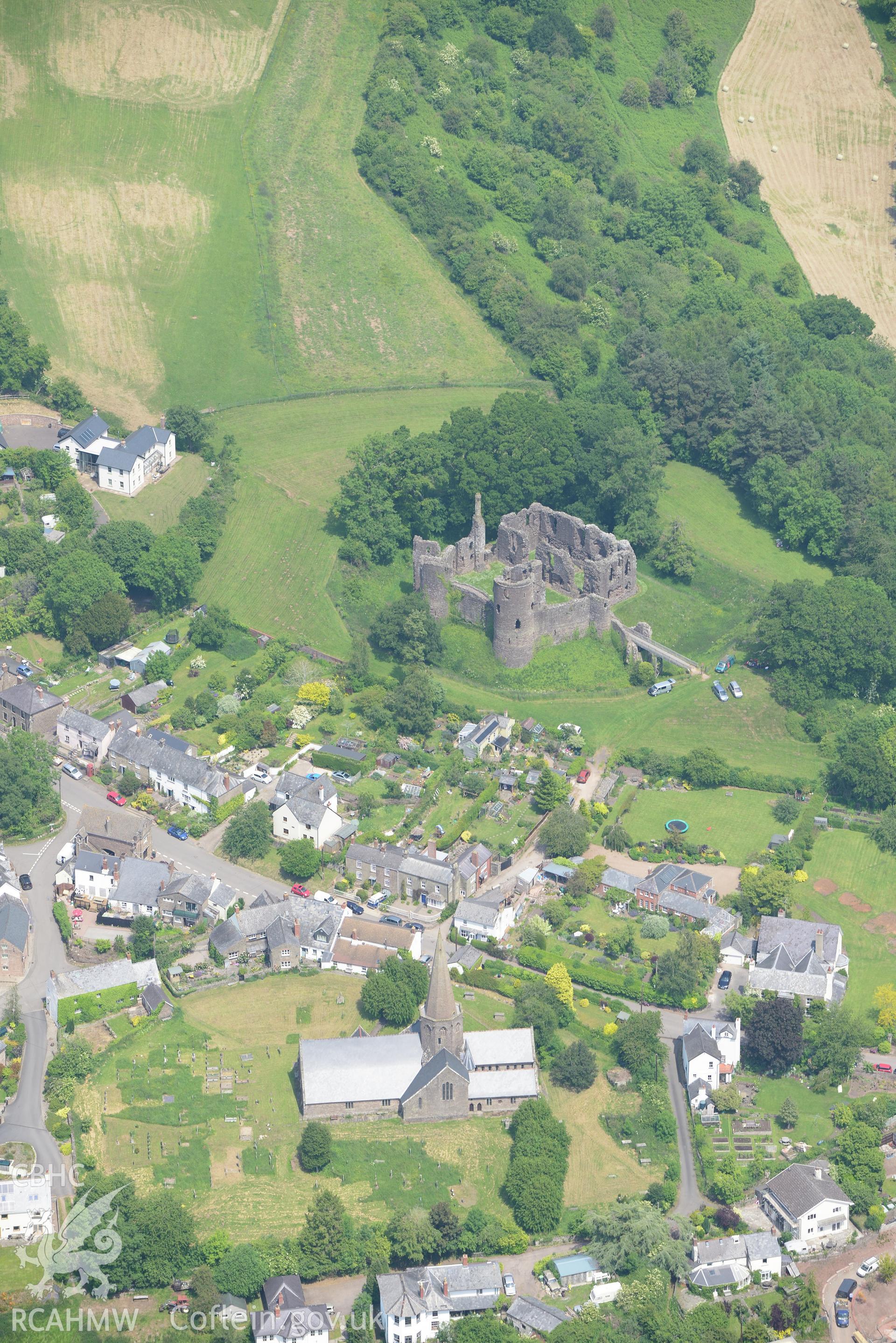 Grosmont village including views of the castle and St. Nicholas' church. Oblique aerial photograph taken during the Royal Commission's programme of archaeological aerial reconnaissance by Toby Driver on 11th June 2015.