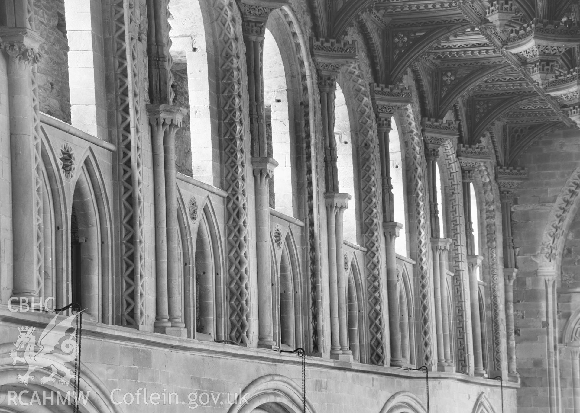 Digital copy of a black and white nitrate negative showing detailed interior view of decorated window arches at St. David's Cathedral, taken by E.W. Lovegrove, July 1936.