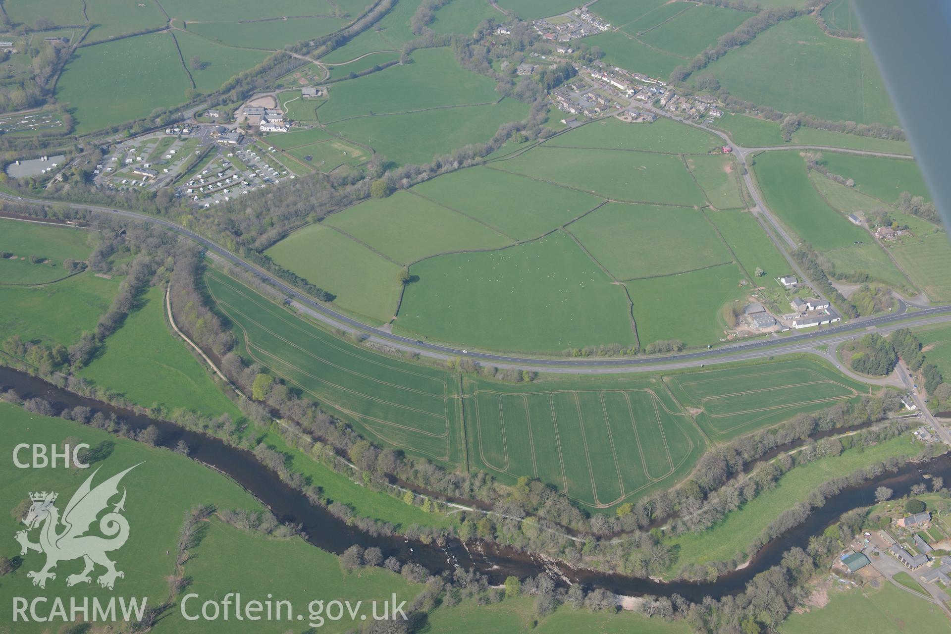 Cefn-Brynich Roman Fort and Cefn Brynich Farm including farmhouse, garden, barns and outbuildings. Oblique aerial photograph taken during the Royal Commission's programme of archaeological aerial reconnaissance by Toby Driver on 21st April 2015