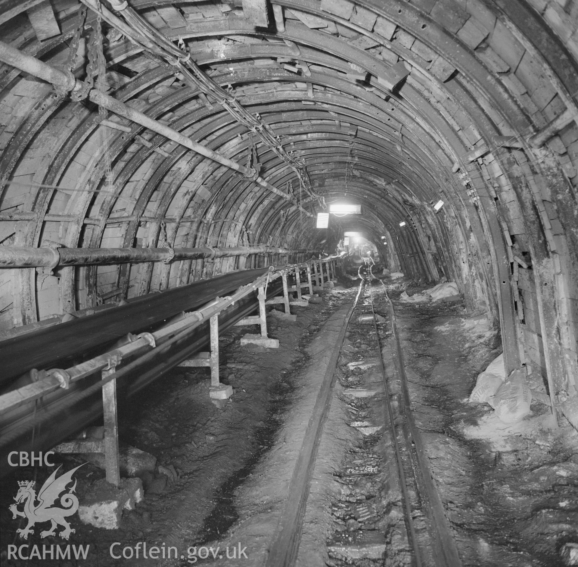 Digital copy of an acetate negative showing "Trunk road with conveyor looking outbye, New Mine", Big Pit, from the John Cornwell Collection.
