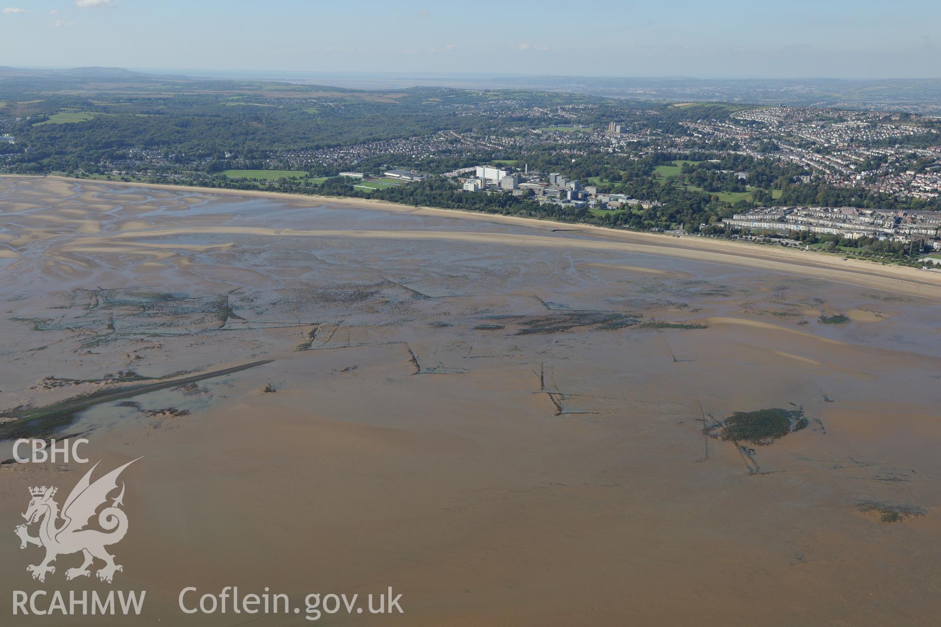 Fishtraps off the coast of Swansea Bay, with Swansea University and Swansea city beyond. Oblique aerial photograph taken during the Royal Commission's programme of archaeological aerial reconnaissance by Toby Driver on 30th September 2015.