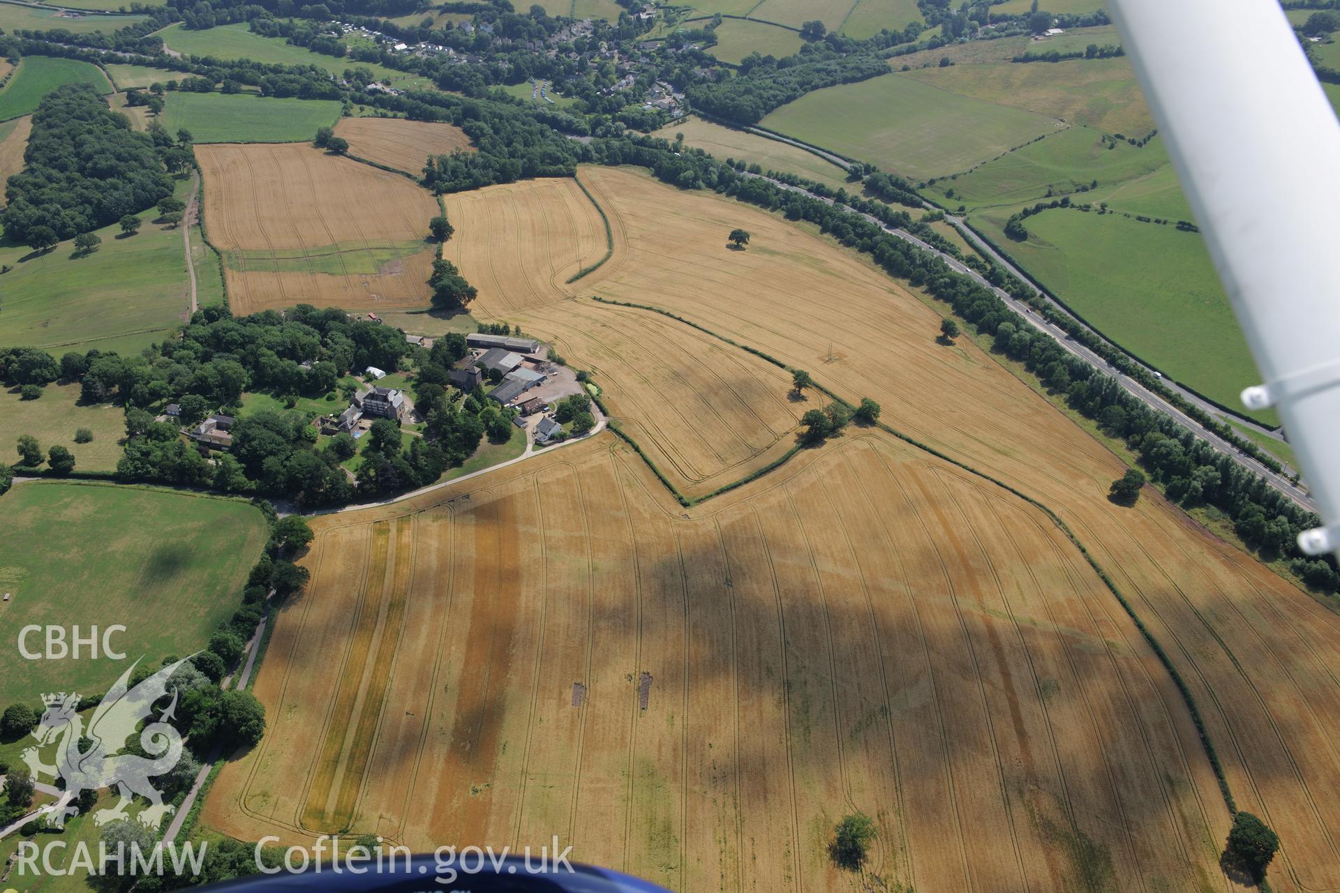 Wonastow court and garden, with the village of Mitchell Troy beyond. Oblique aerial photograph taken during the Royal Commission?s programme of archaeological aerial reconnaissance by Toby Driver on 1st August 2013.
