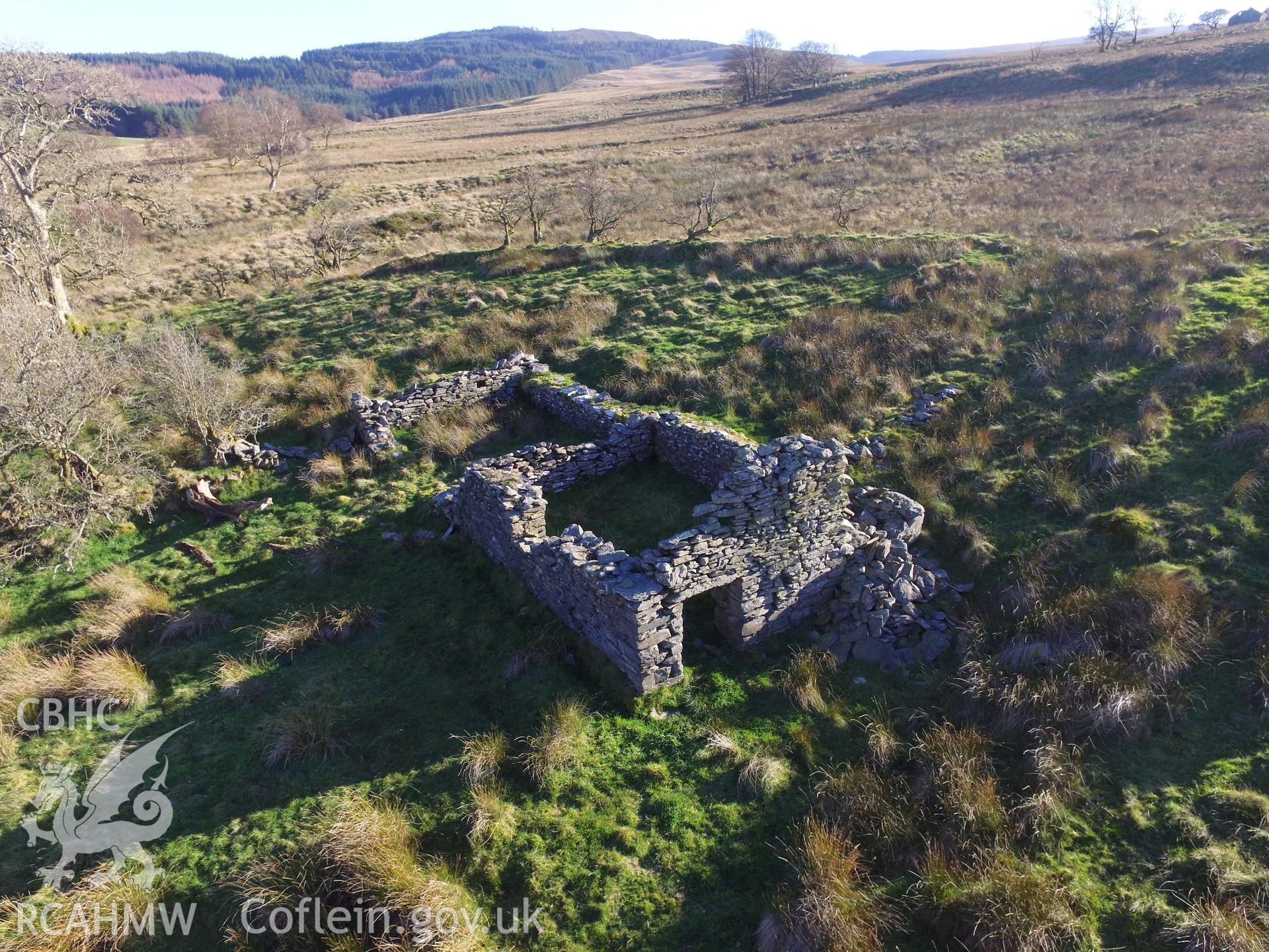 Aerial view of the remains of a doorway and stone walls belonging to a cottage west of the ruined Caradog house, which is south west of Bryneithinog farm, Ystrad Fflur. Colour photograph taken by Paul R. Davis on 18th November 2018.