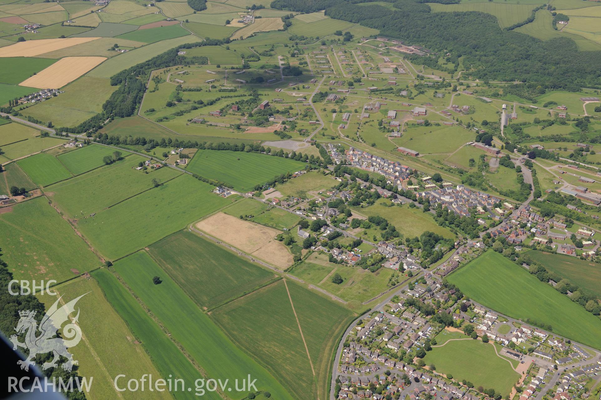 Caerwent Roman town and the Royal Naval Propellant Factory beyond. Oblique aerial photograph taken during the Royal Commission's programme of archaeological aerial reconnaissance by Toby Driver on 29th June 2015.
