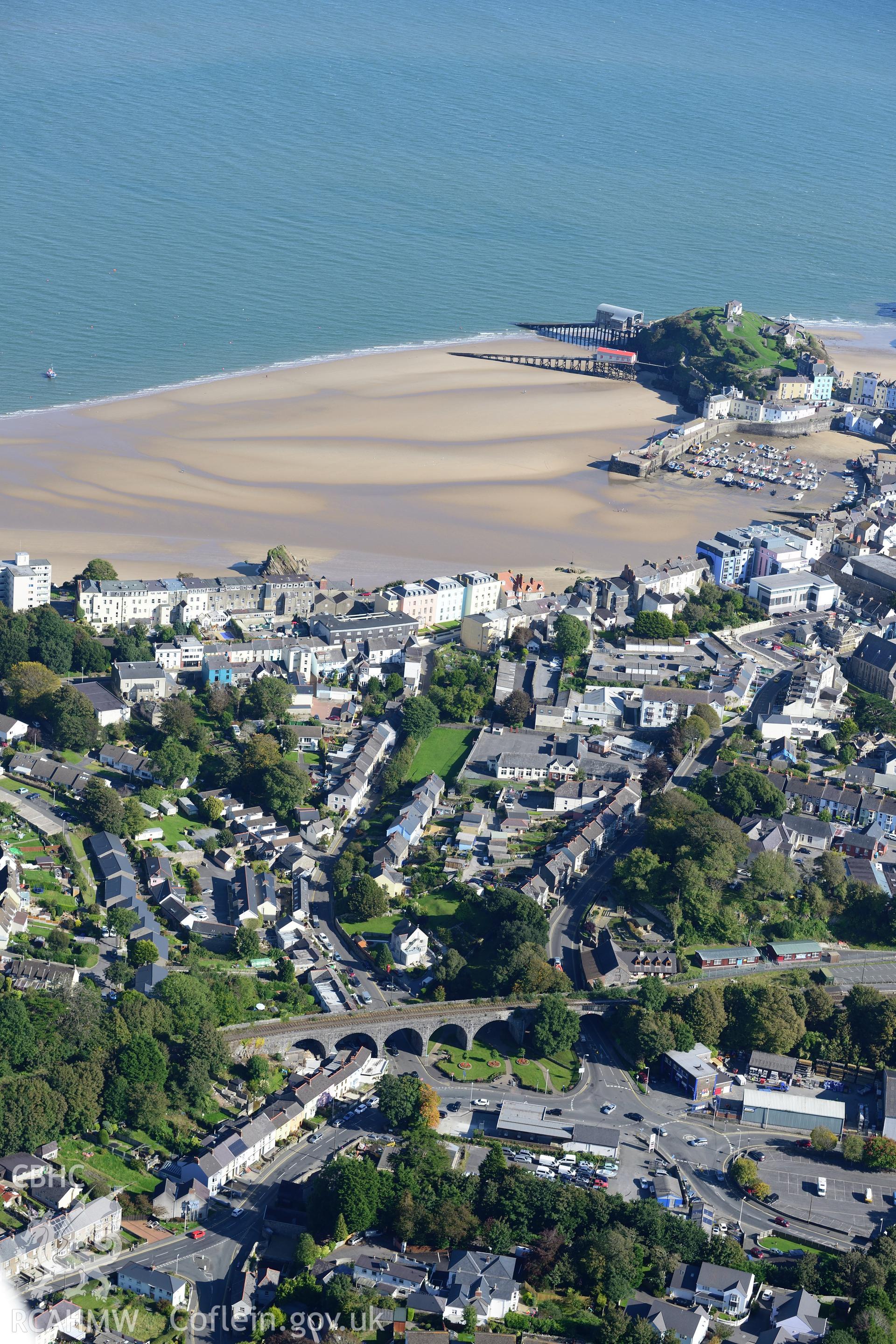 Tenby and it's castle, harbour and railway viaduct. Oblique aerial photograph taken during the Royal Commission's programme of archaeological aerial reconnaissance by Toby Driver on 30th September 2015.