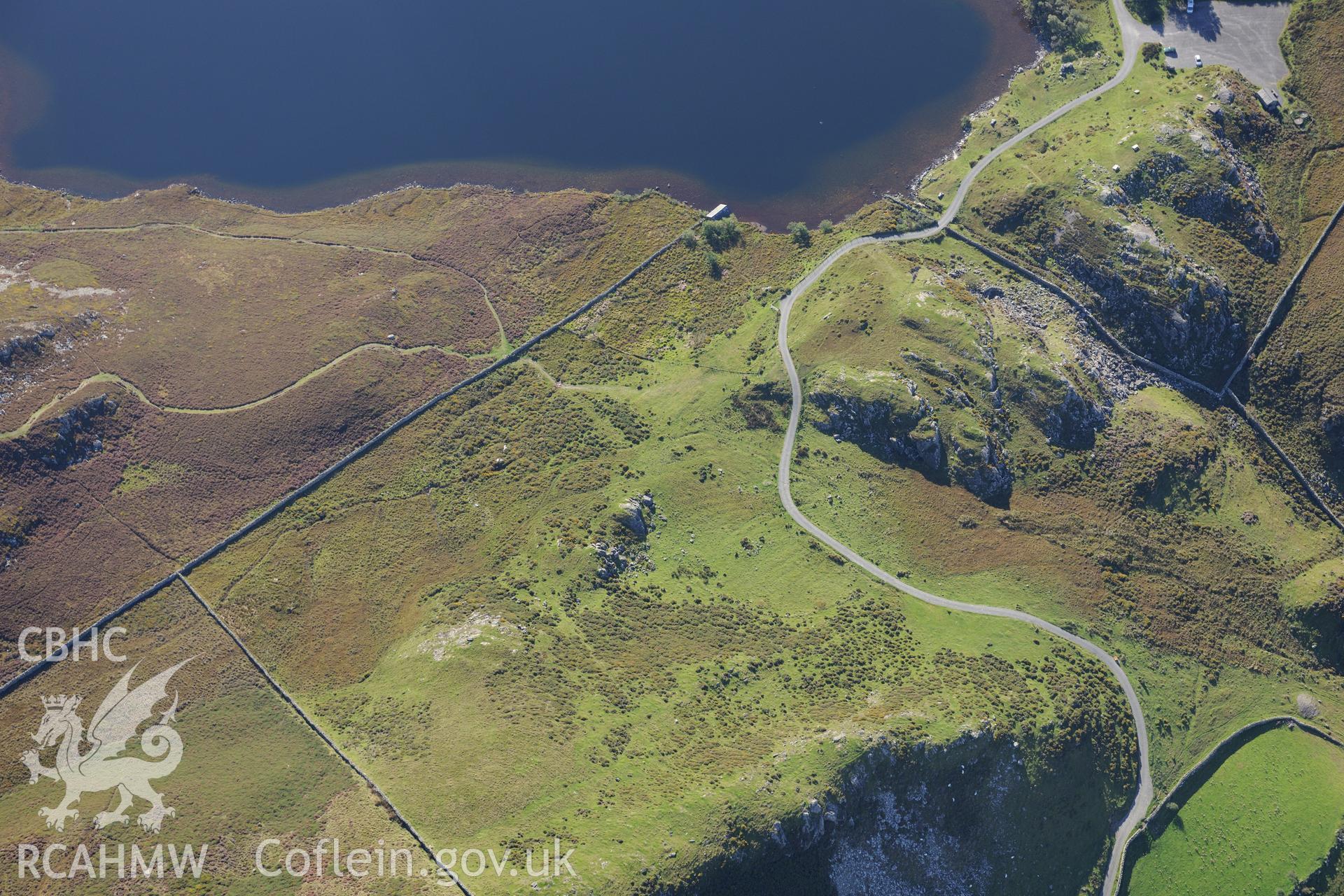 Two cairns and remains of drystone building at Llynnau Cregennen on the slopes of Cadair Idris. Oblique aerial photograph taken during the Royal Commission's programme of archaeological aerial reconnaissance by Toby Driver on 2nd October 2015.