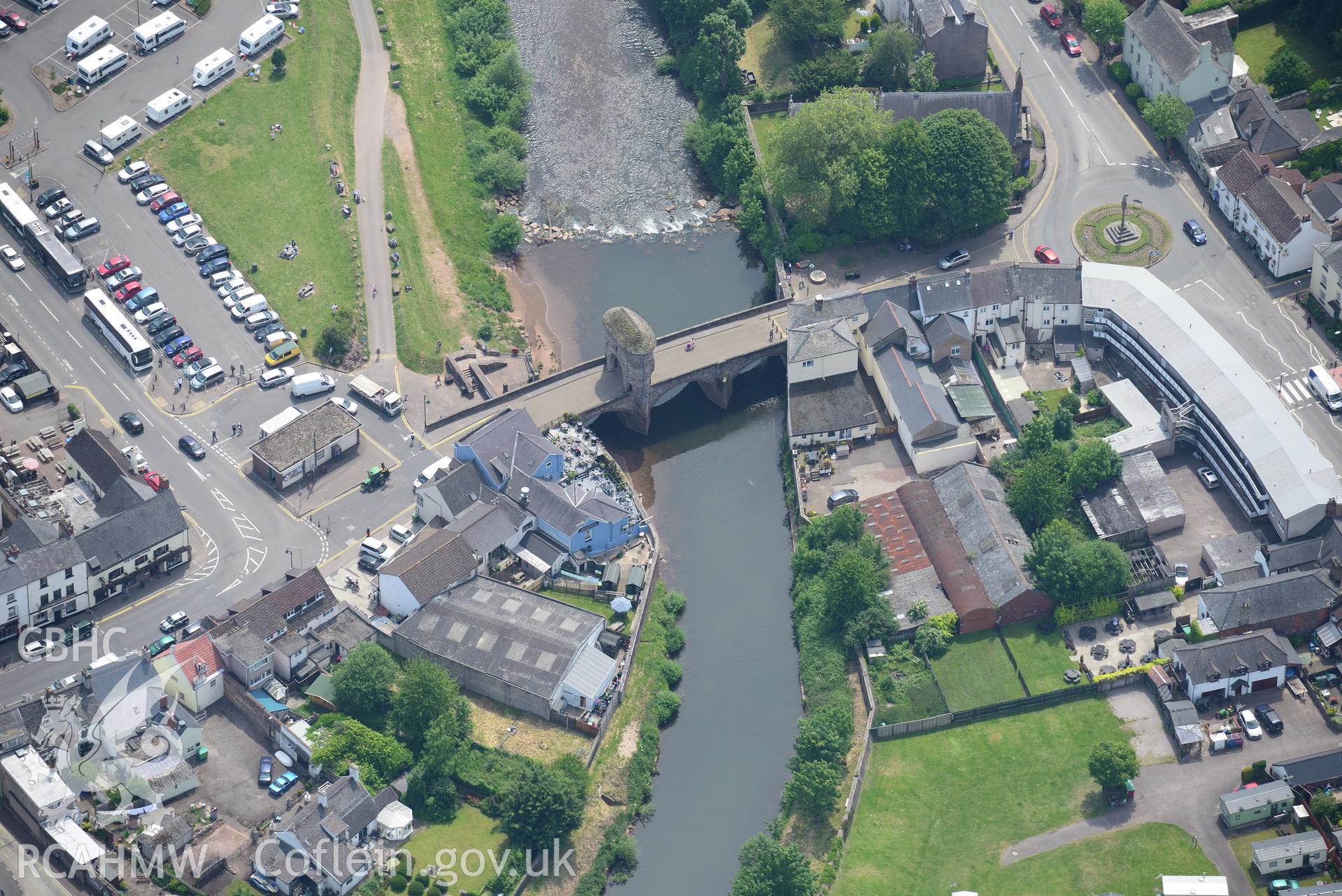 Monnow bridge and gate; St. Thomas' Square and St. Thomas's Church, Monmouth. Oblique aerial photograph taken during the Royal Commission's programme of archaeological aerial reconnaissance by Toby Driver on 11th June 2015.
