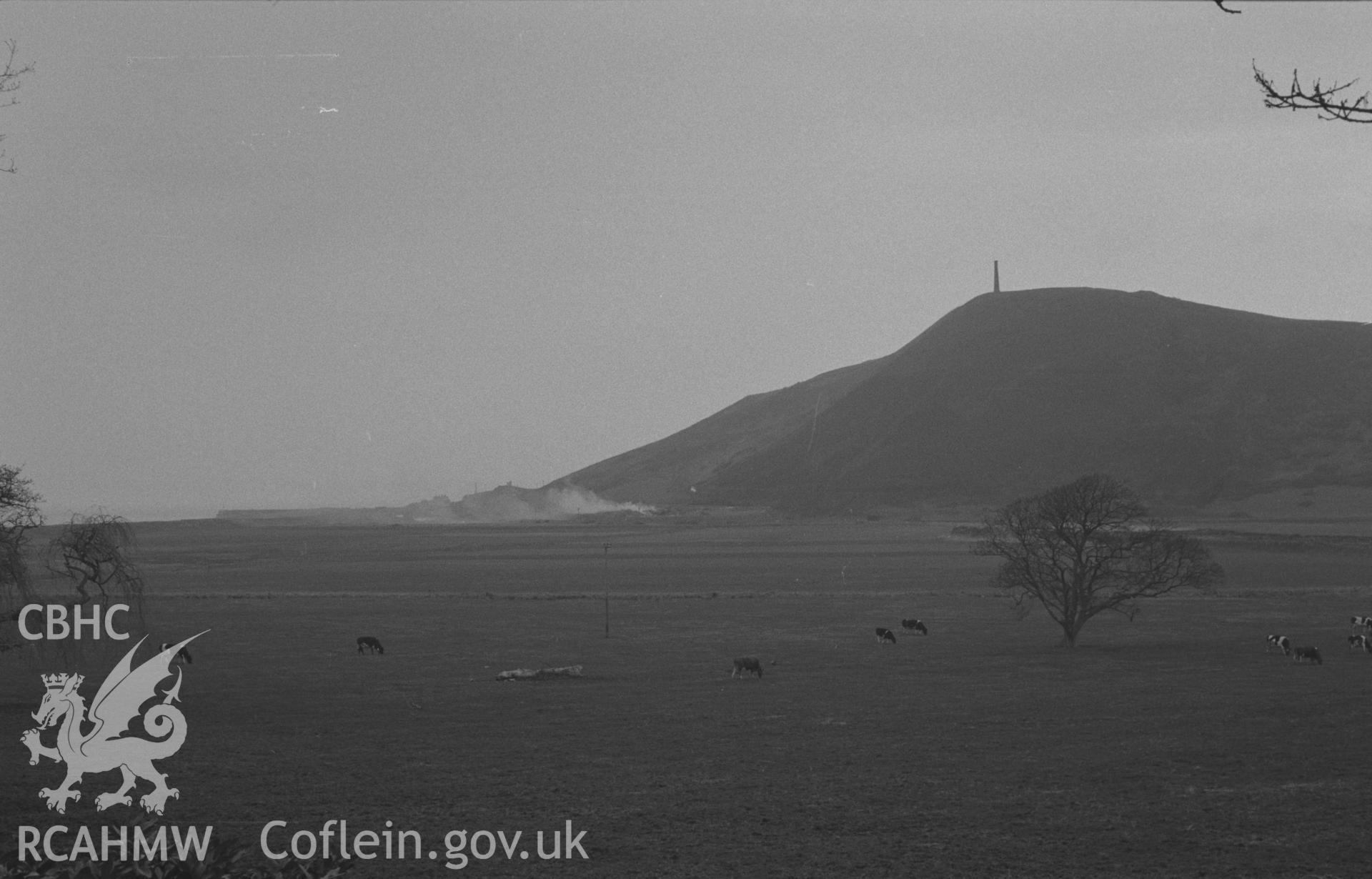 Black and White photograph showing Pen Dinas and the stone pier from the drive 300m south east of Tanybwlch House. Photographed by Arthur Chater in April 1962 from Grid Reference SN 583 792, looking north.