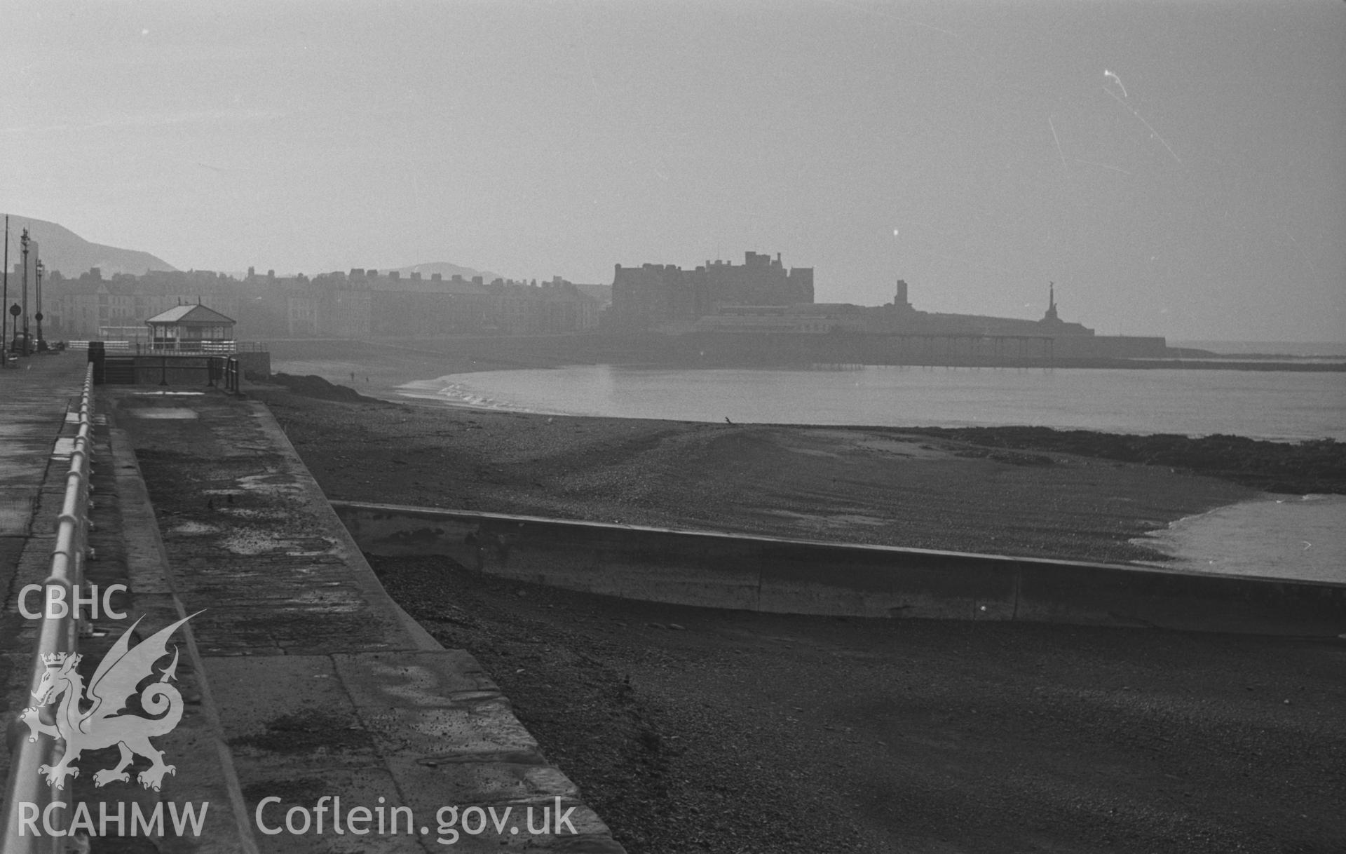Black and White photograph showing Aberystwyth Promenade, with distant views of Marine Terrace, the Old College, Pier Pavillion and the Castle. Photographed by Arthur Chater in December 1962, from Grid Reference SN 5833 8232, looking south.