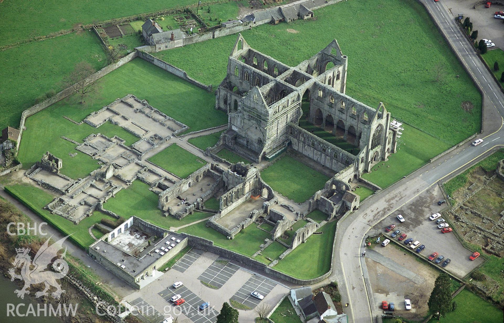 RCAHMW colour slide oblique aerial photograph of Tintern Abbey, Tintern, taken by C.R. Musson, 24/03/94