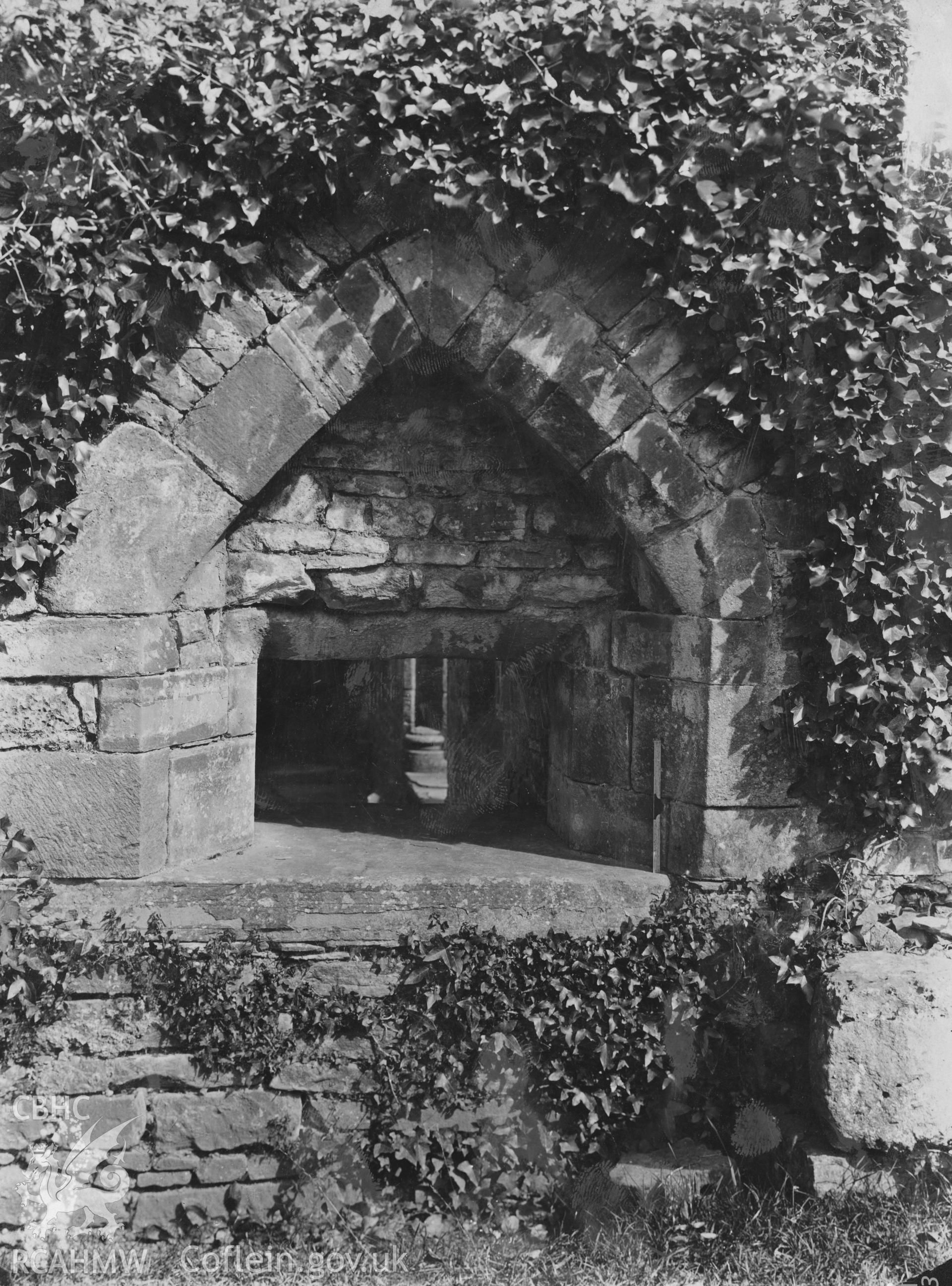 Digital copy of an early National Buildings Record photograph showing the serving hatch from the kitchen at Tintern Abbey.