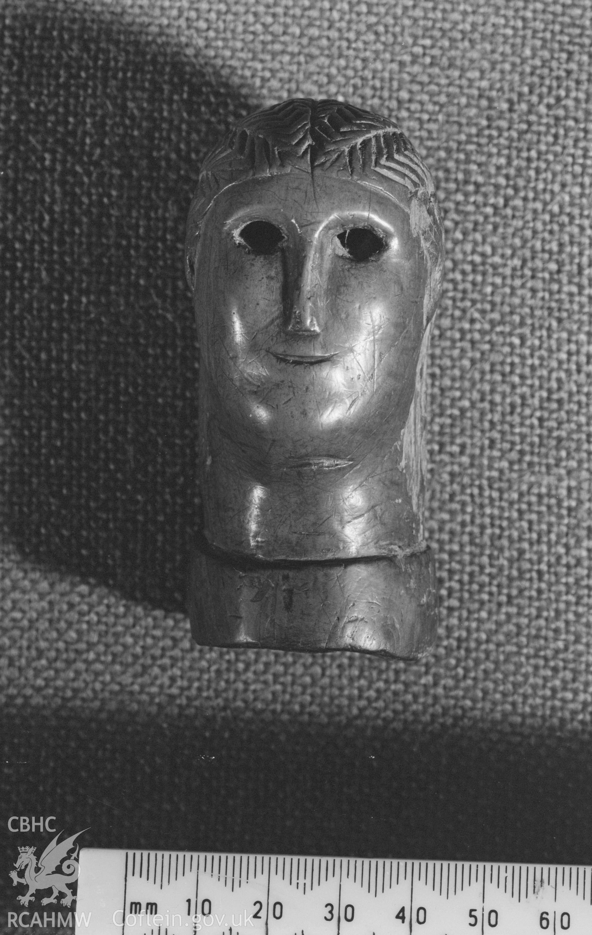 Digital copy of a photo showing a carved wooden head from Llanio Roman Fort.