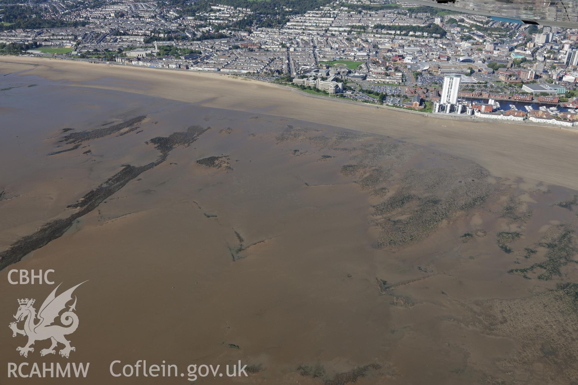 Fishtraps off Swansea bay, with the County Hall, Meridian Quay Development and Swansea city beyond. Oblique aerial photograph taken during the Royal Commission's programme of archaeological aerial reconnaissance by Toby Driver on 30th September 2015.